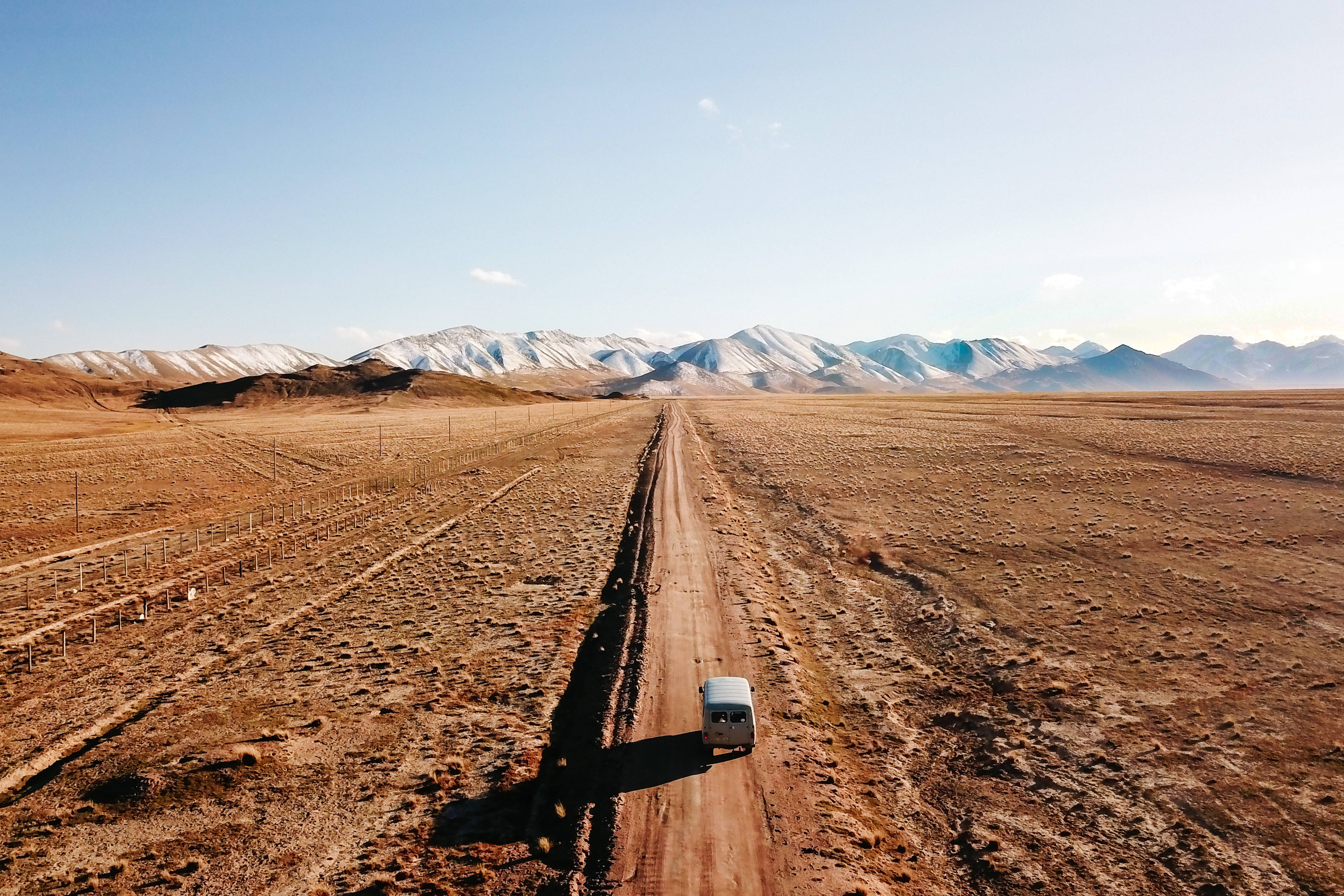 Kyrgyzstan, snow-capped mountains, dirt road, 2K Desktop Wallpaper