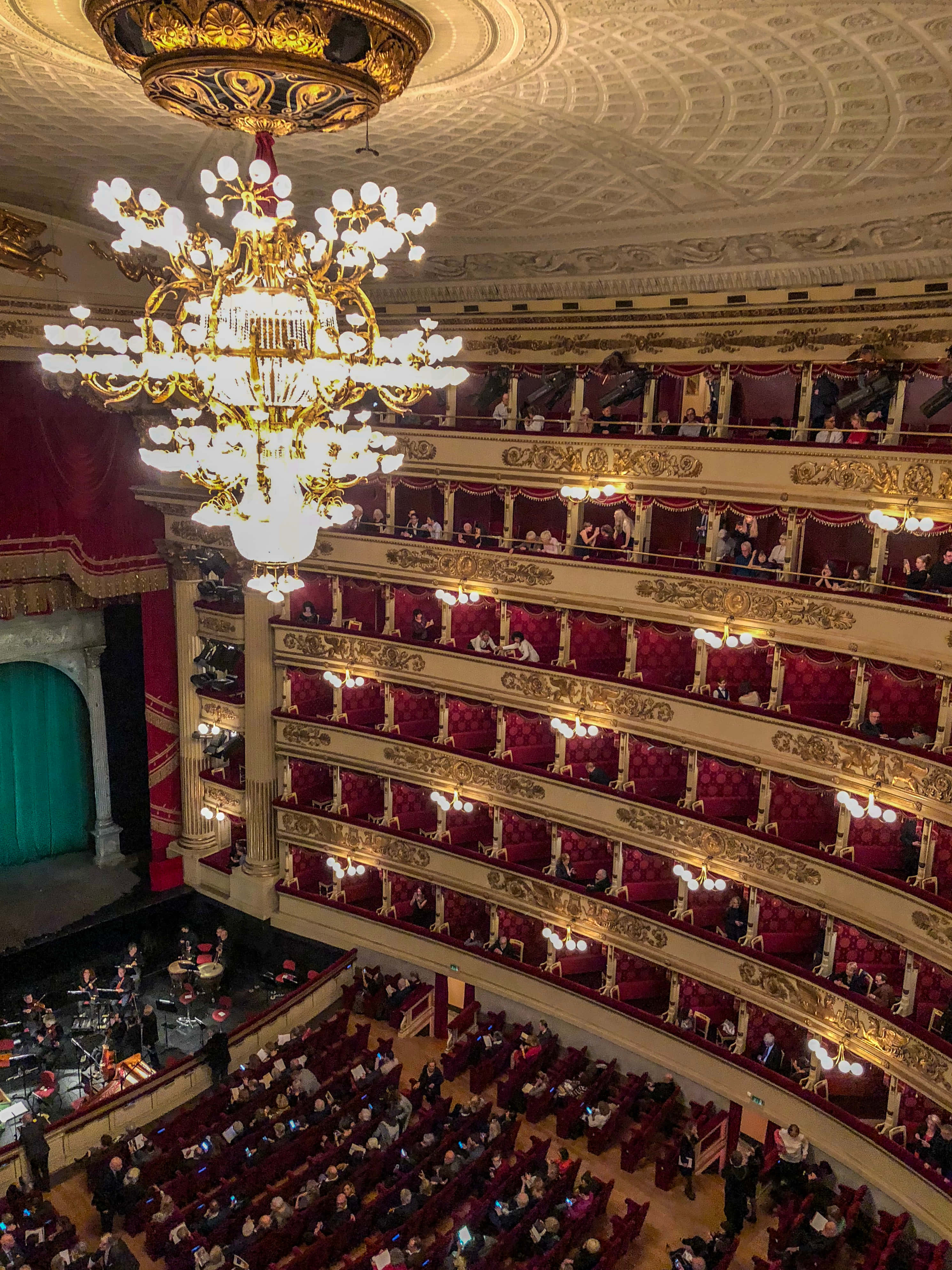 La Scala Opera House, golden chandeliers, red velvet seats, 4K Phone Wallpaper