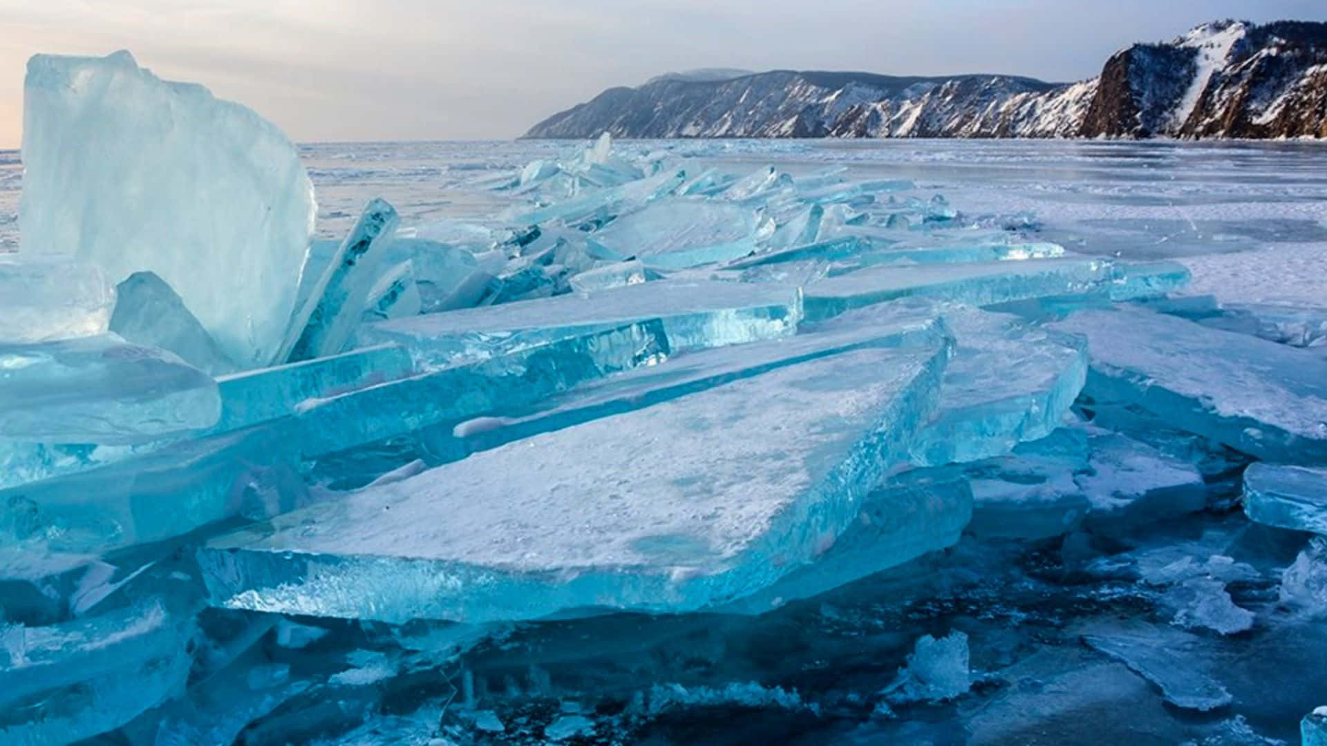 Lake Baikal, translucent blue ice floes, snow-covered mountains, Full HD Desktop Wallpaper