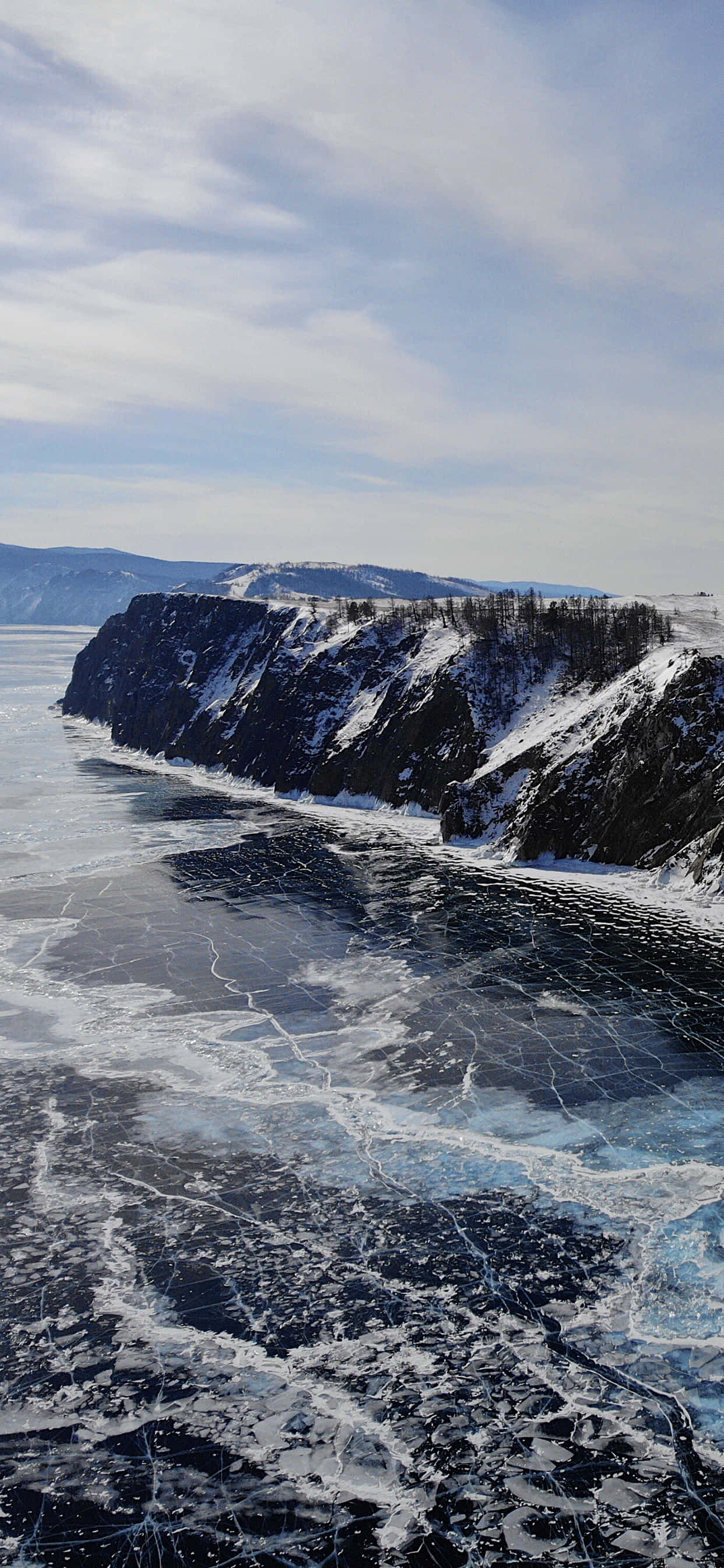 Lake Baikal, icy mountain view, cracked ice patterns, 2K Phone Wallpaper