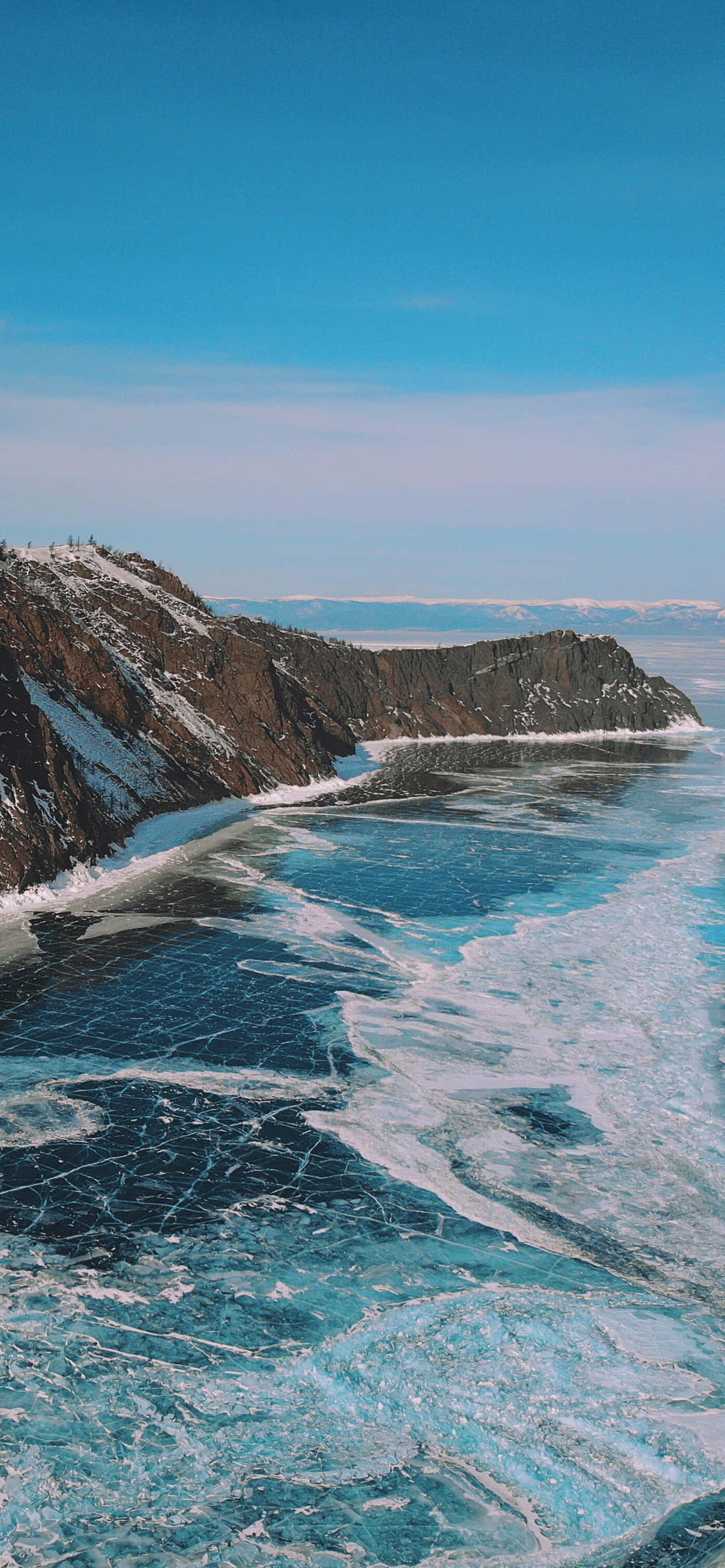 Lake Baikal, frozen coastal landscape, cracked blue ice, 2K Phone Wallpaper