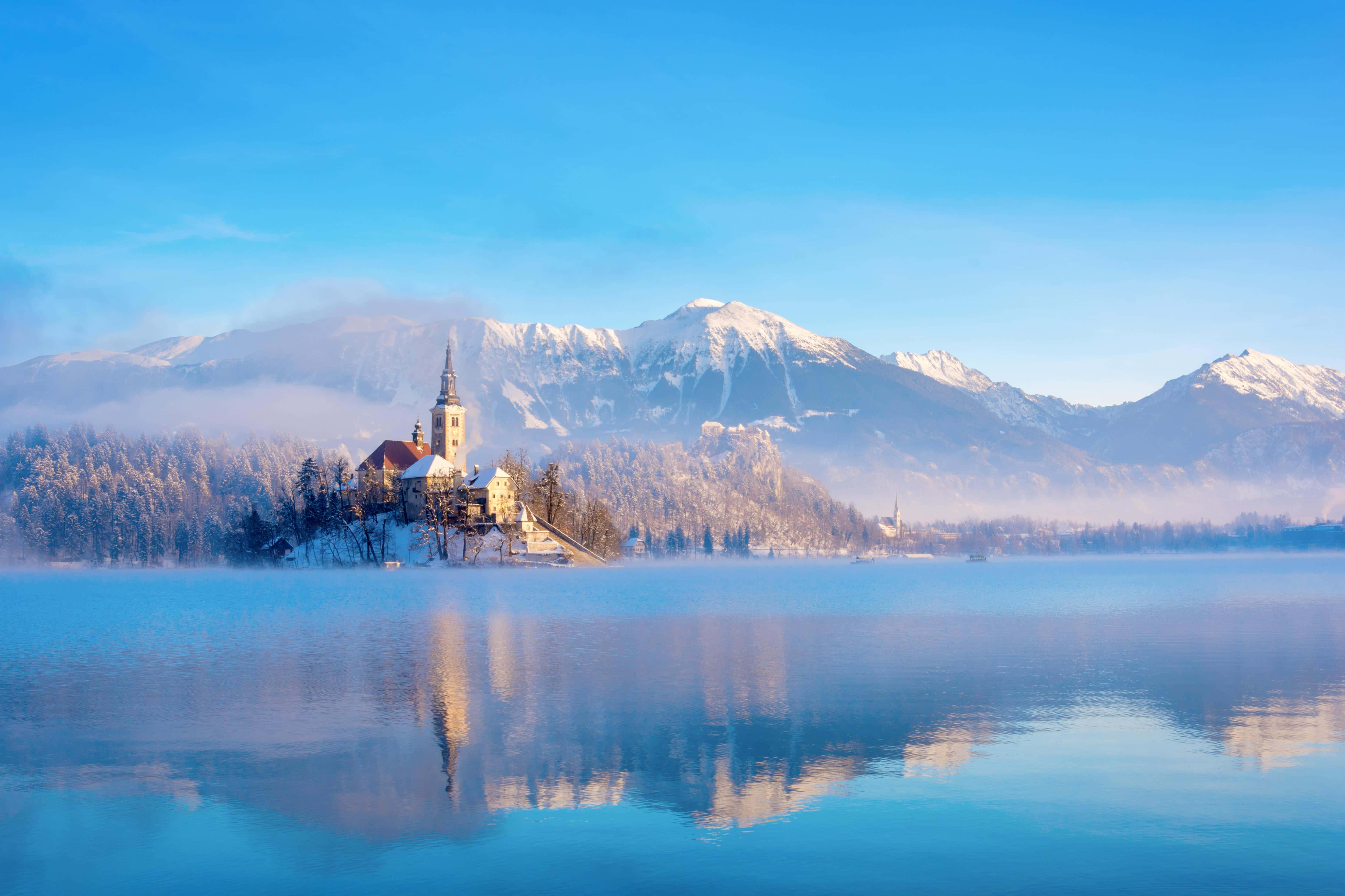 Lake Bled, snow-dusted church, misty mountains, 4K Desktop Wallpaper