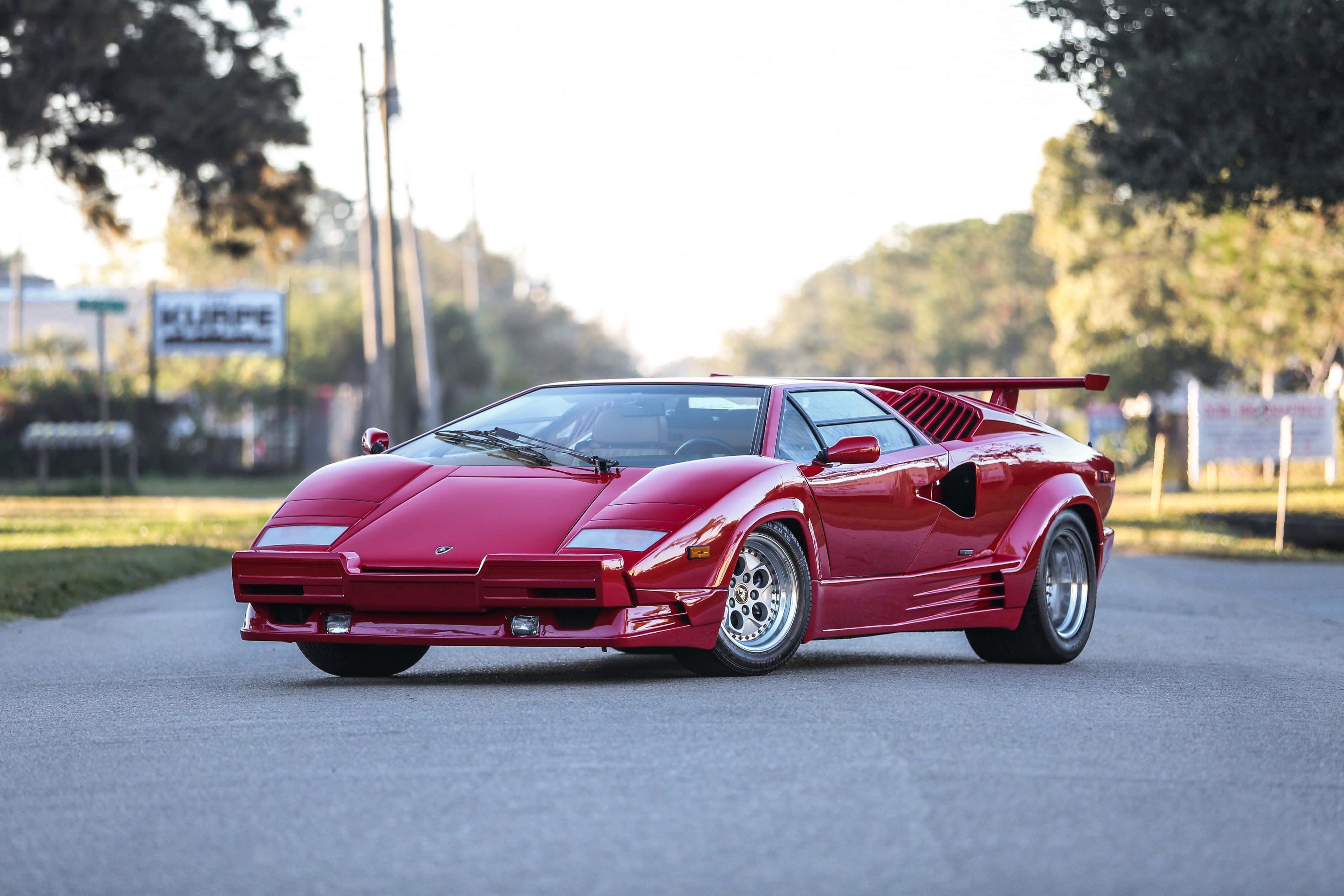 Lamborghini Countach, glossy red, tree-lined road, 4K Desktop Wallpaper