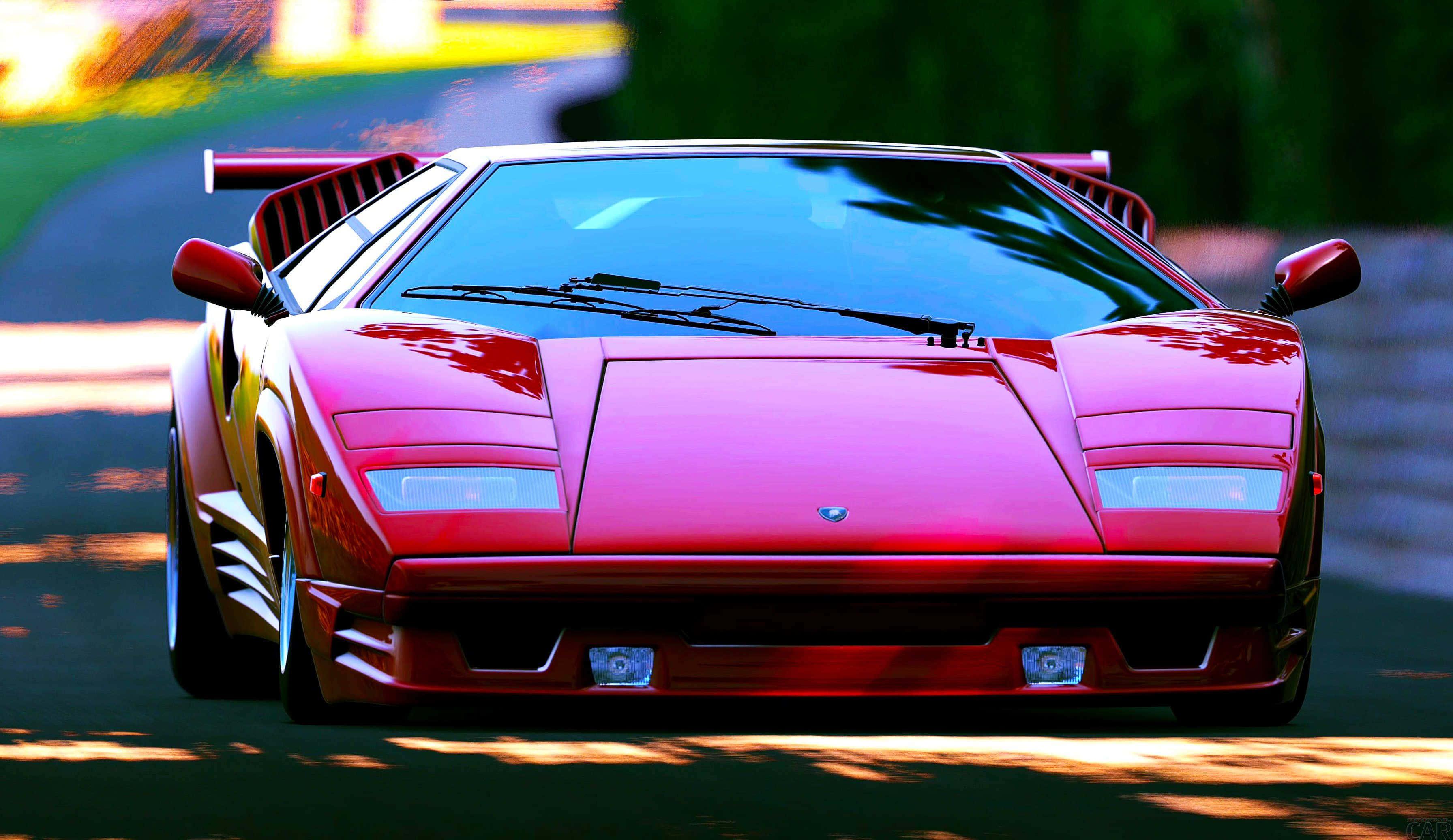 Lamborghini Countach, vibrant red, sunlit road, 2K Desktop Wallpaper