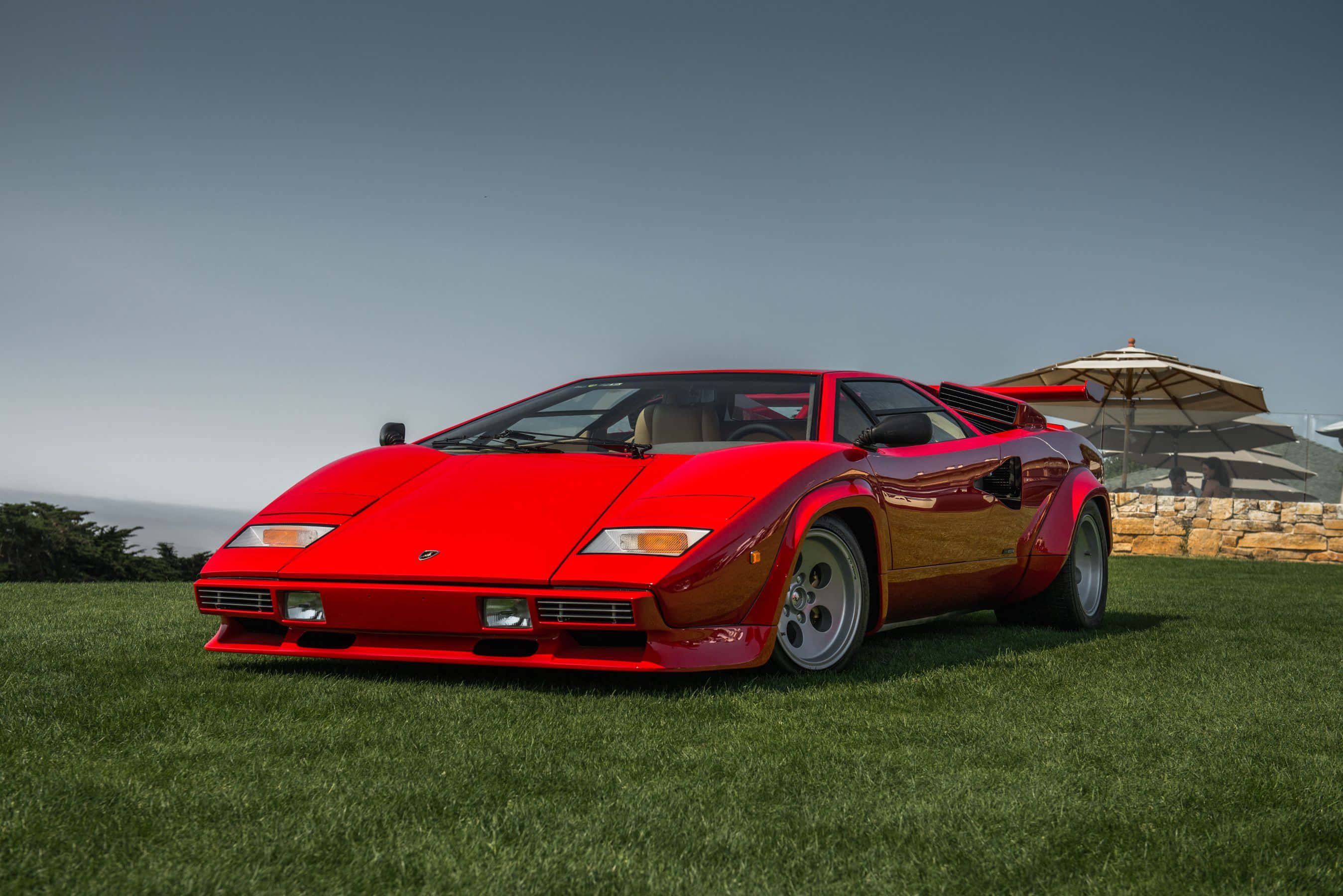 Lamborghini Countach, vibrant red, lush green grass, 2K Desktop Wallpaper