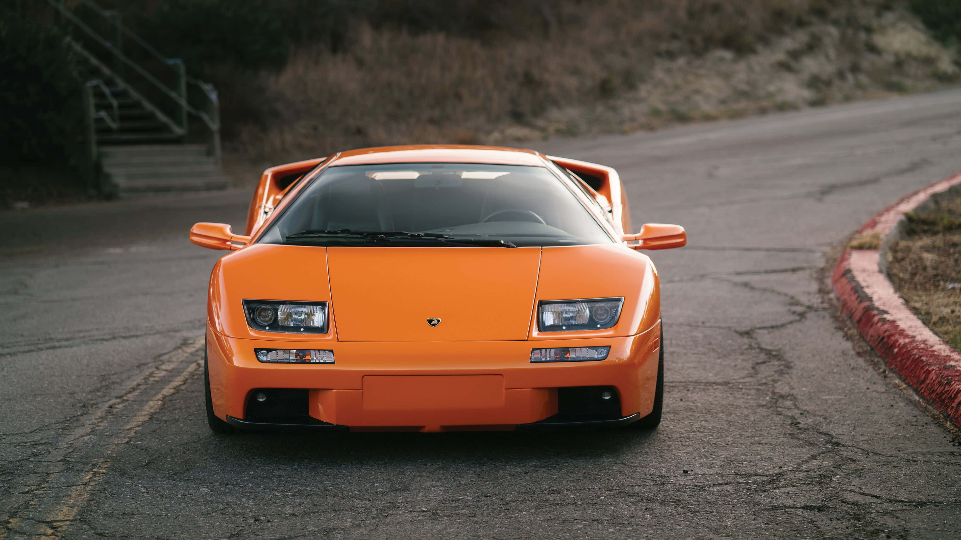 Lamborghini Diablo, vibrant orange, winding asphalt road, 4K Desktop Wallpaper