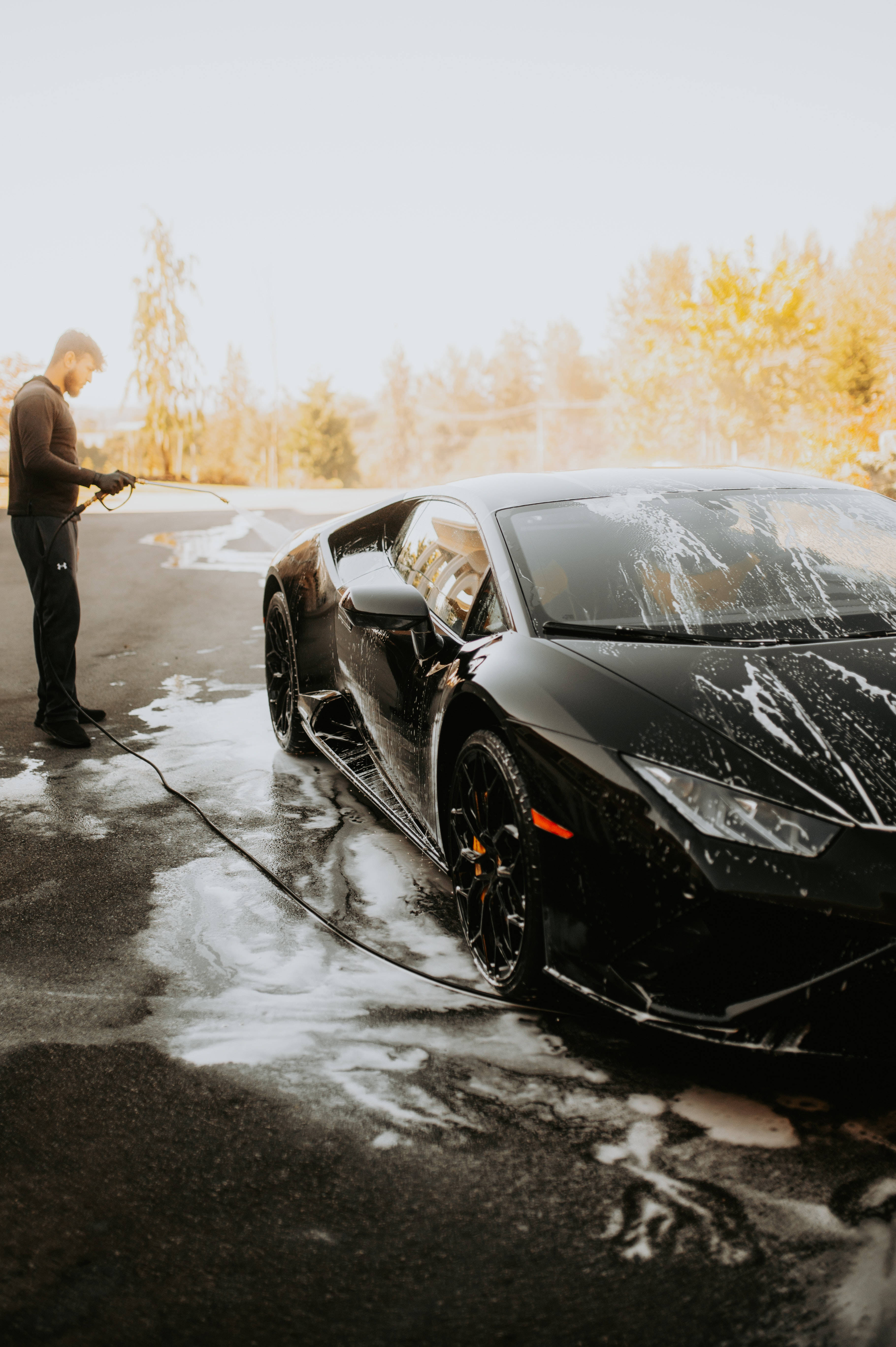 Lamborghini Galaxy, sleek black sports car, warm golden sunlight, 5K Phone Wallpaper