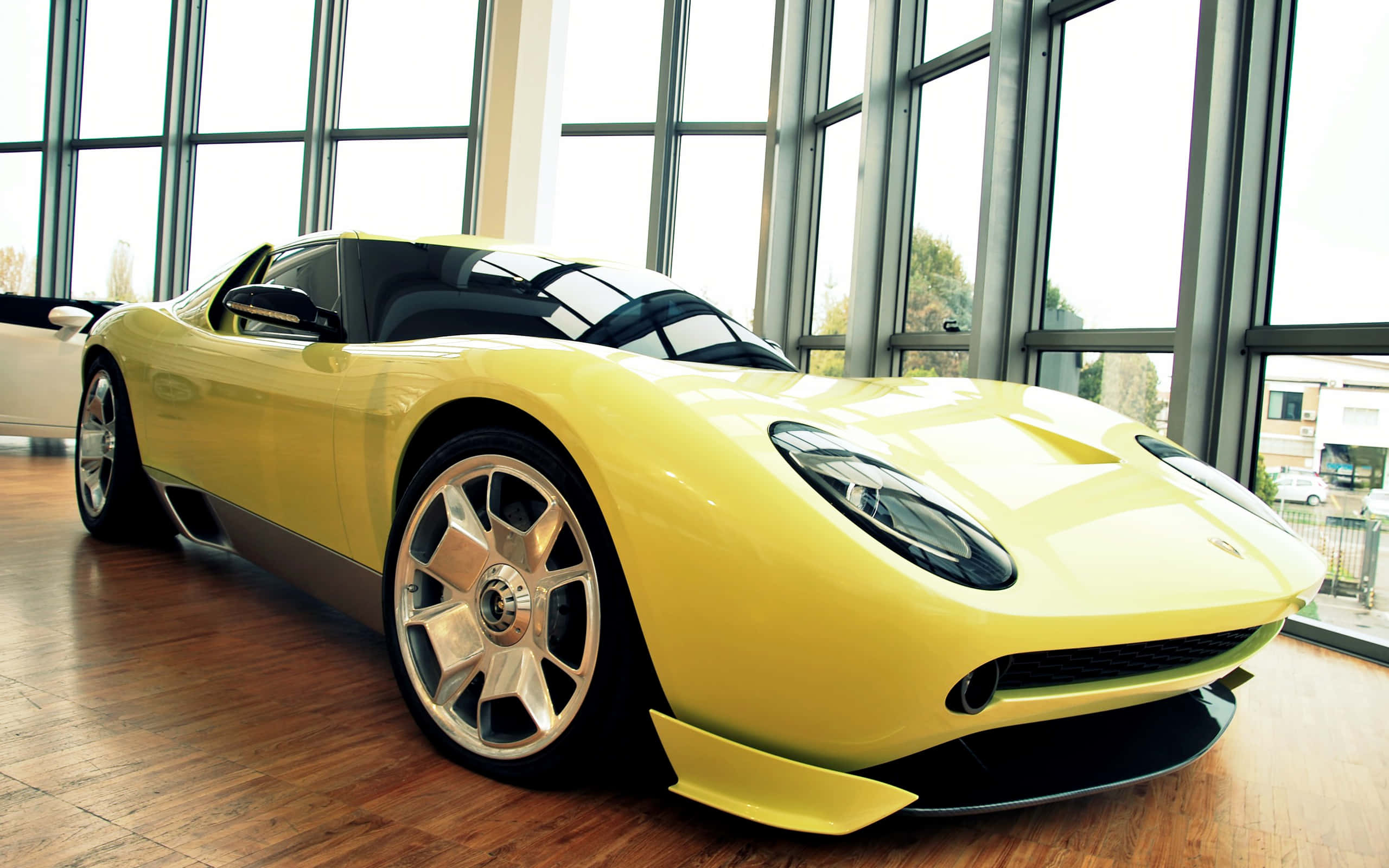 Lamborghini Miura, vibrant yellow, modern glass-walled showroom, 2K Desktop Wallpaper