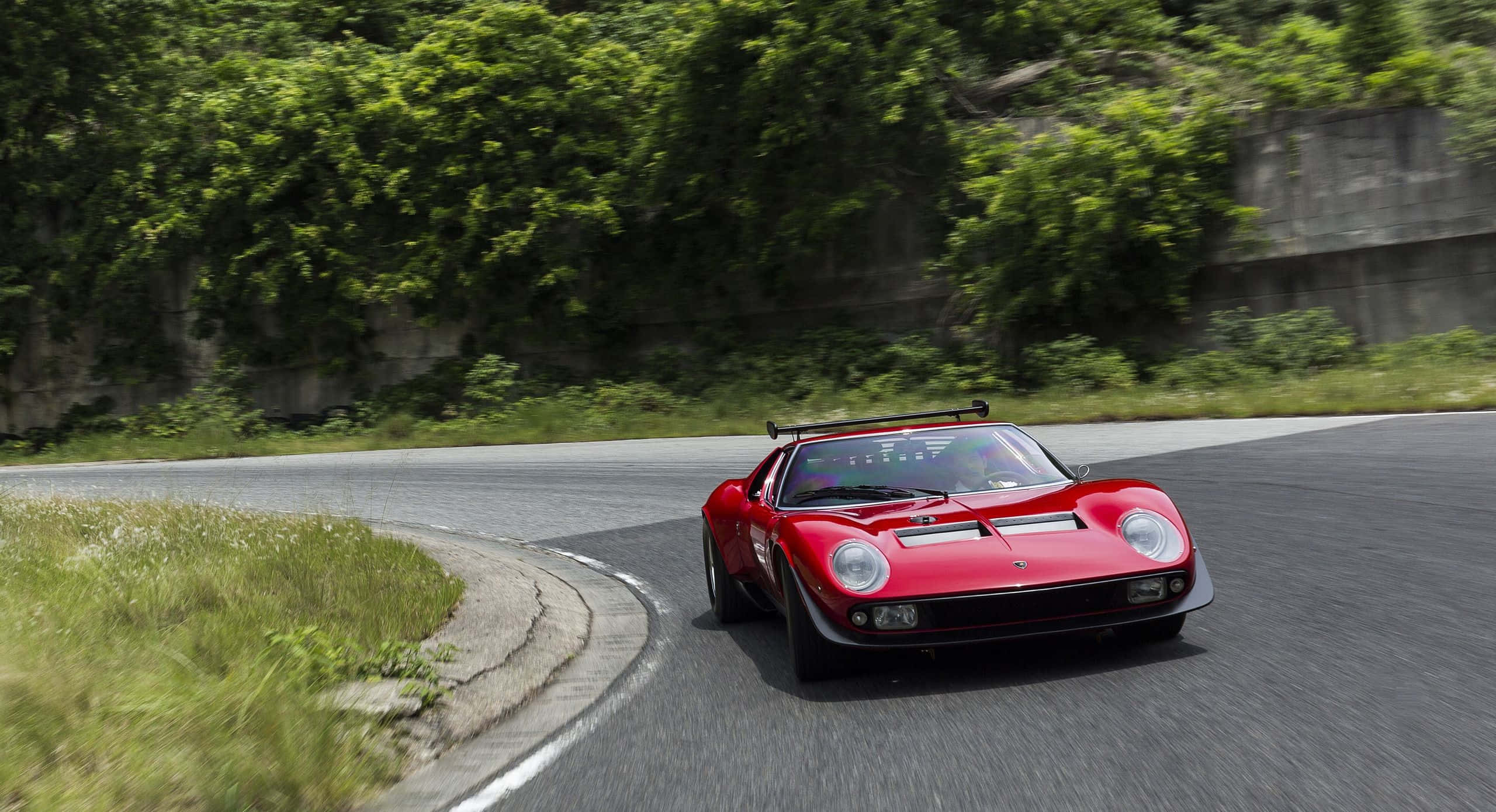 Lamborghini Miura, vibrant red, winding mountain road, 2K Desktop Wallpaper