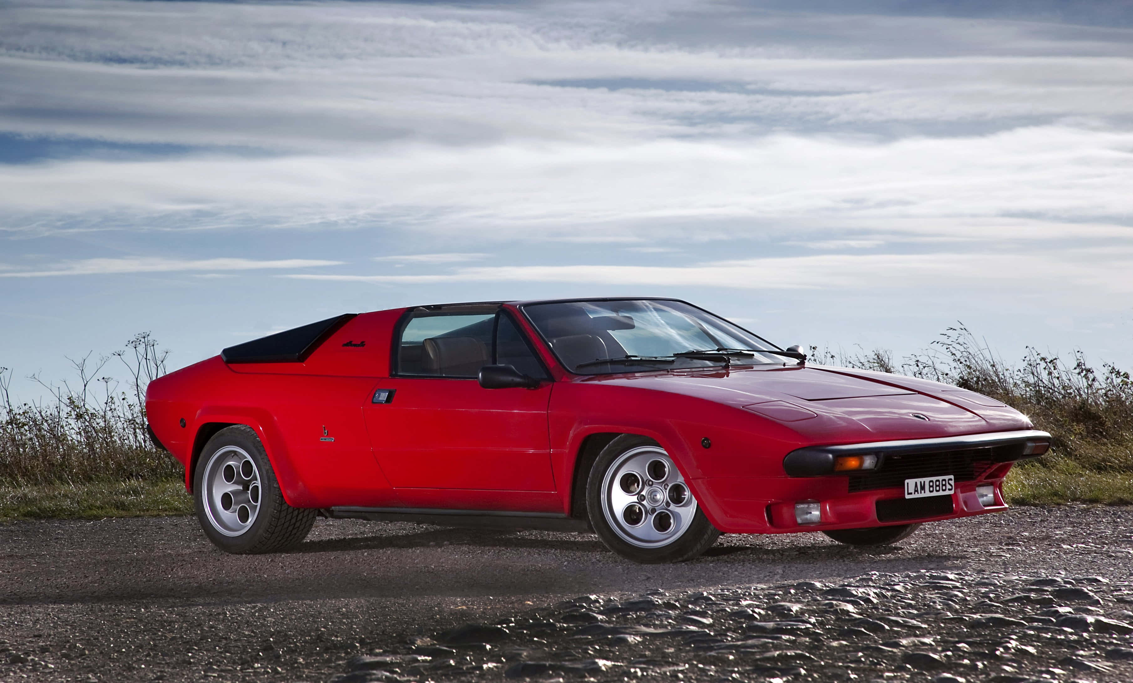Lamborghini Silhouette, vibrant red, wet gravel road, 2K Desktop Wallpaper
