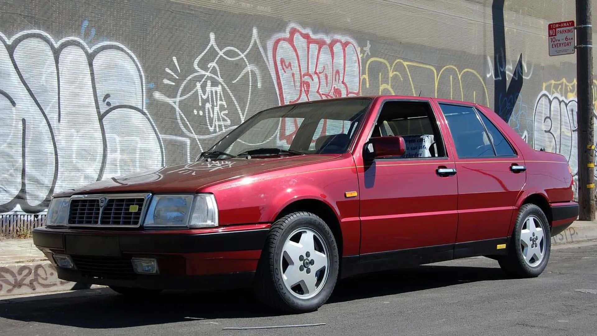 Red Lancia Thema, glossy red, graffiti-covered concrete wall, Full HD Desktop Wallpaper