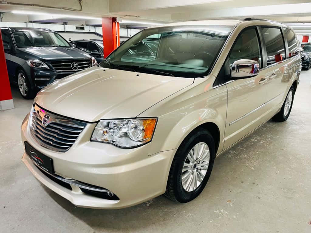 Lancia Voyager, beige minivan, well-lit indoor garage, SD Desktop Wallpaper