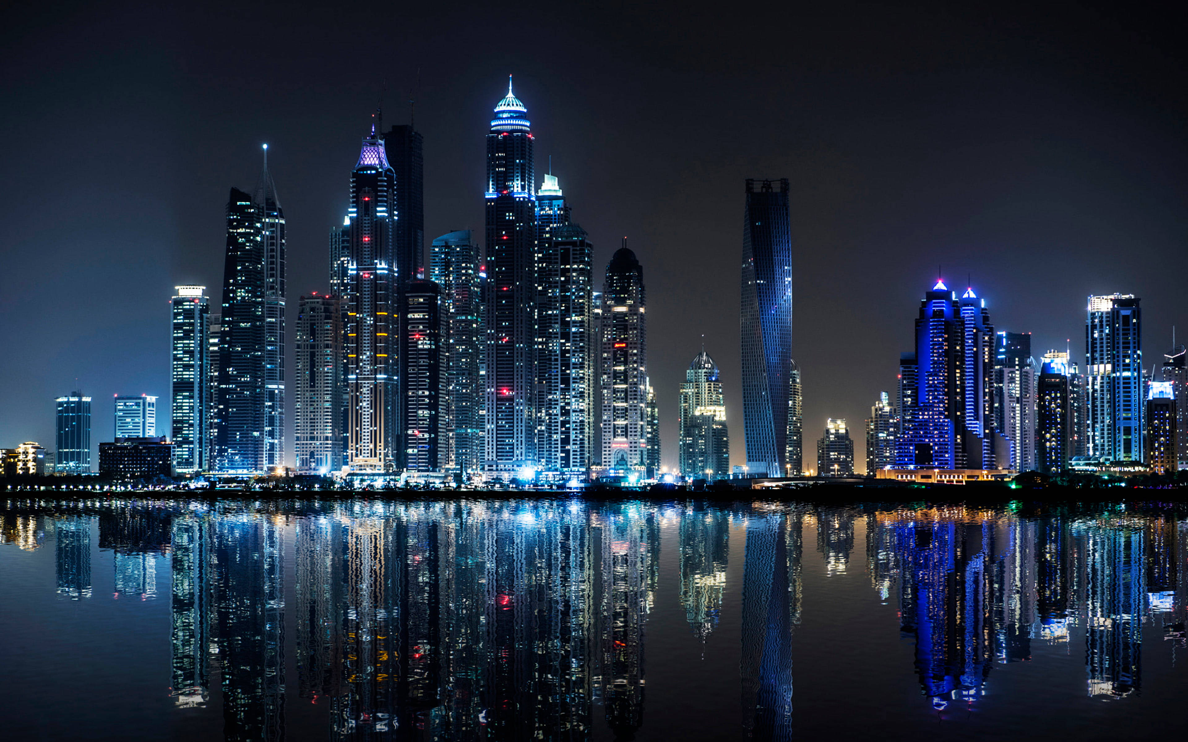 City Landscape At Night, towering skyscrapers, blue and white lights, 4K Desktop Wallpaper