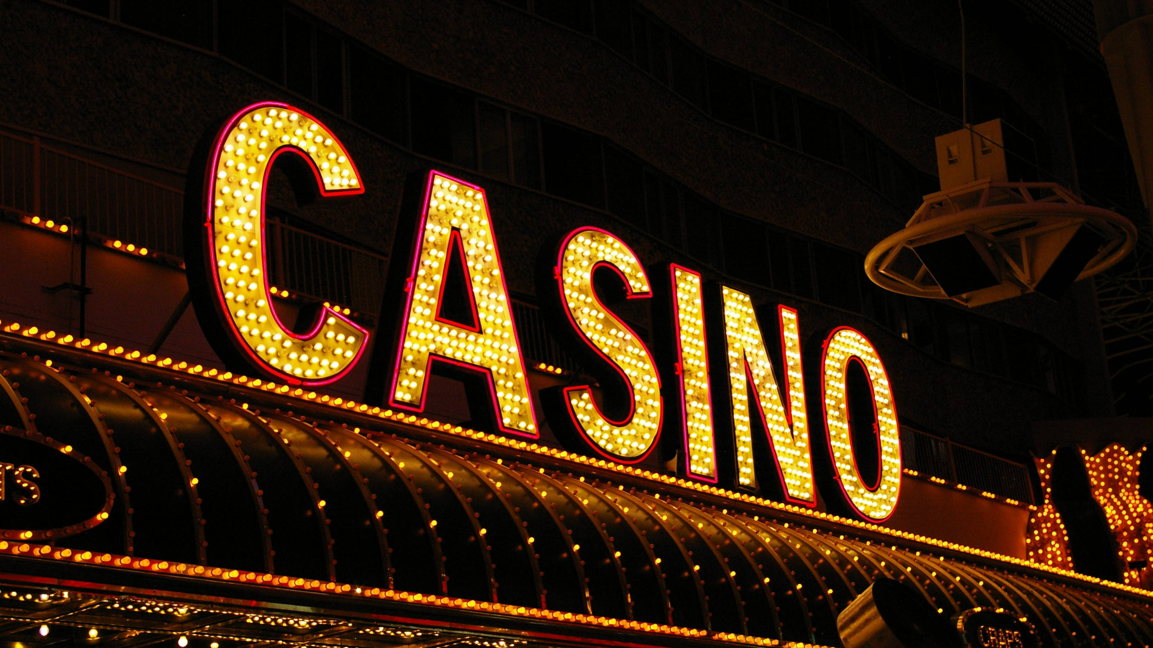 Las Vegas skyline, neon 'CASINO' sign, dark urban night sky, 4K Desktop Wallpaper