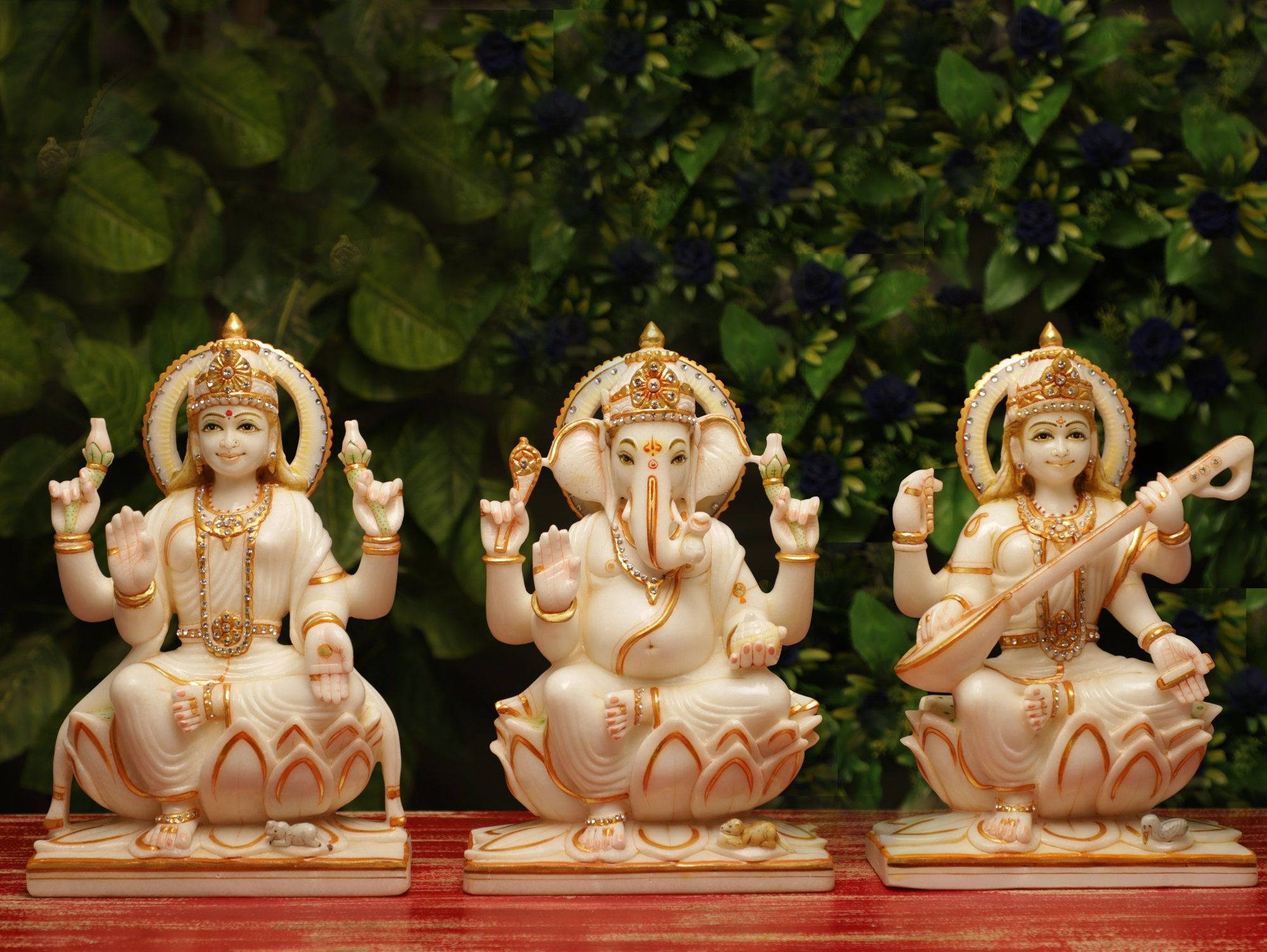 Laxmi Ganesh Saraswati, white marble Hindu deity statues, red wooden surface, Full HD Desktop Wallpaper