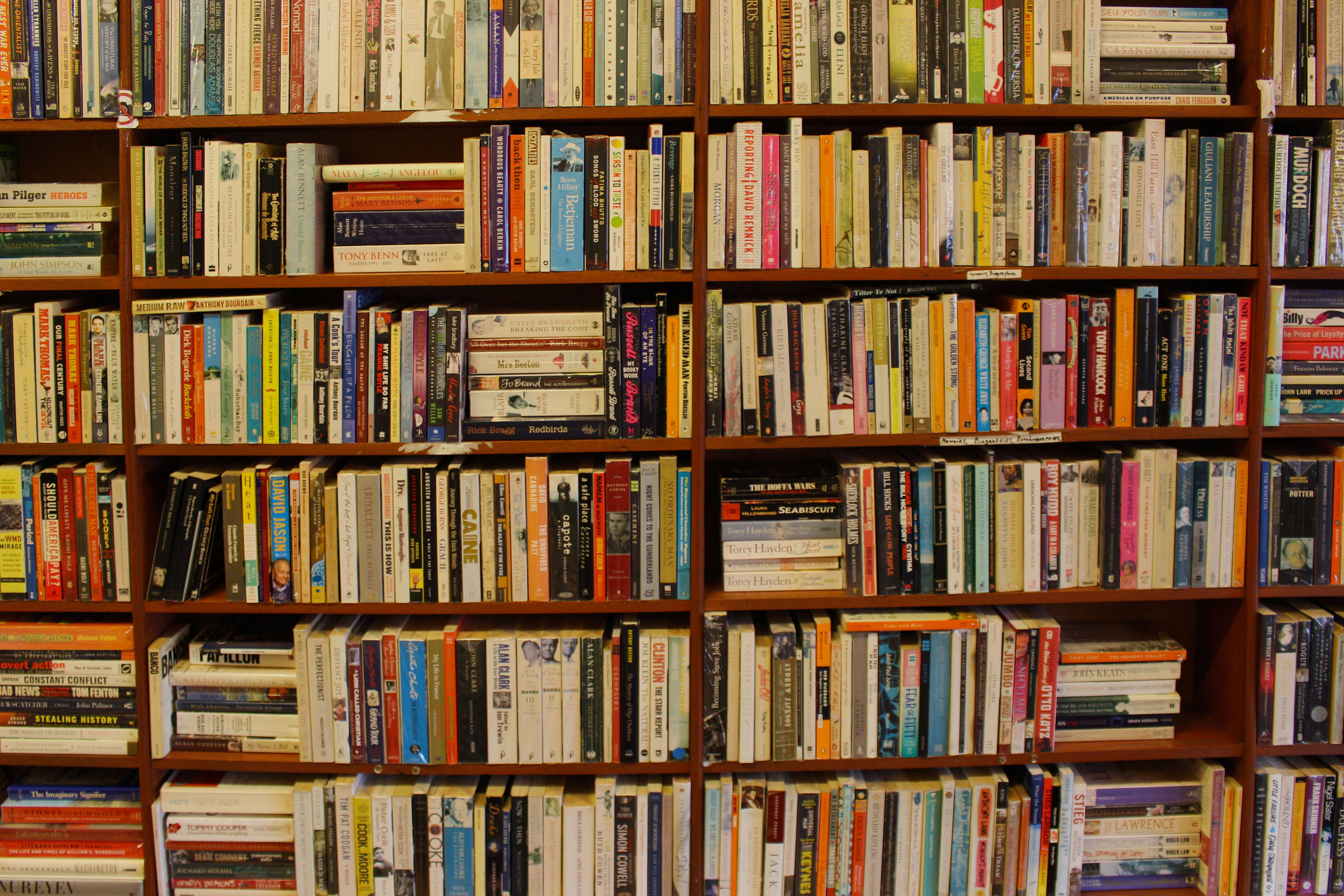 wooden bookshelf, densely packed books, varied colors, 5K Desktop Wallpaper
