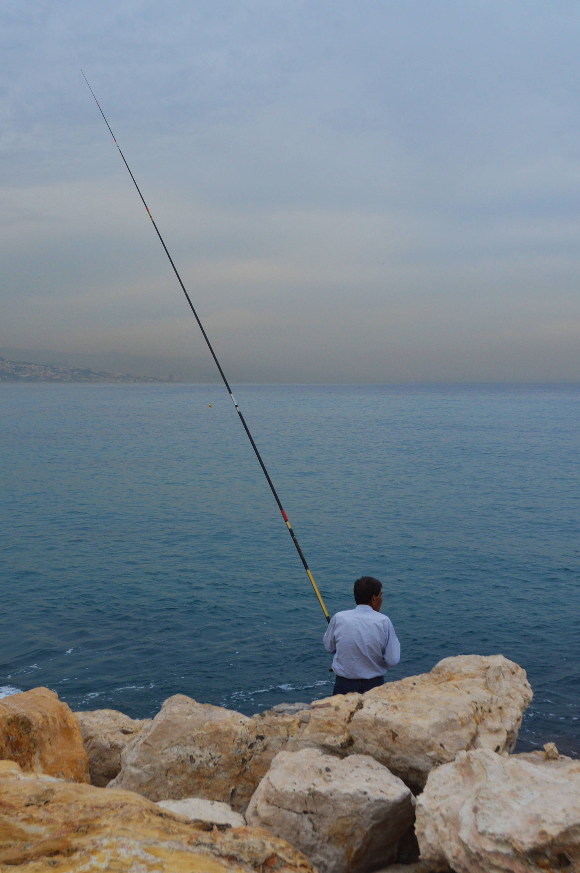fishing in lebanon, rocky cliffs, calm blue sea, 2K Phone Wallpaper