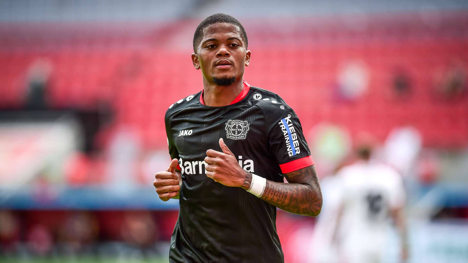 Leon Bailey, black jersey, sunlit stadium field, Full HD Desktop Wallpaper