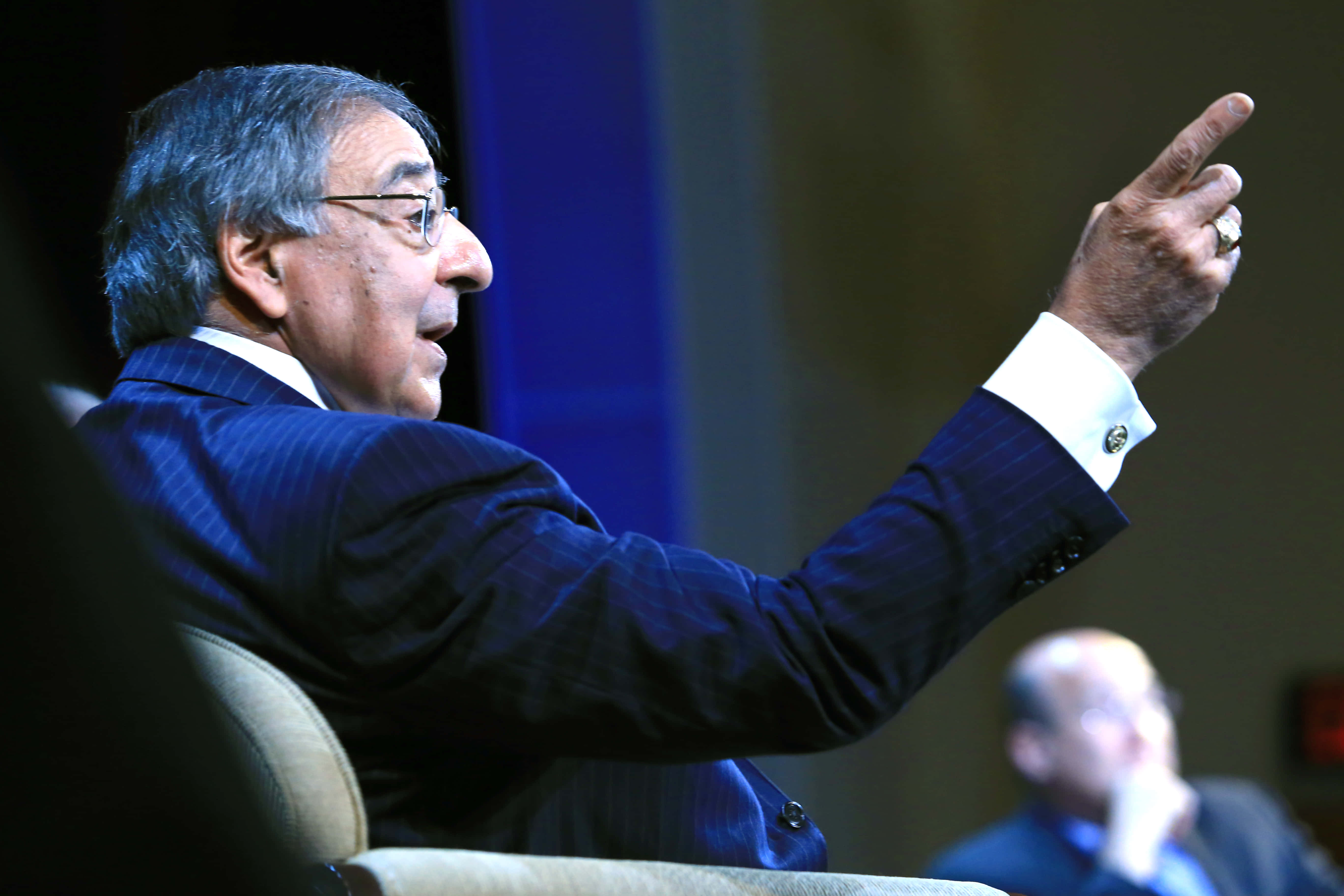 Leon Panetta, dark pinstripe suit, dimly lit conference room, 5K Desktop Wallpaper
