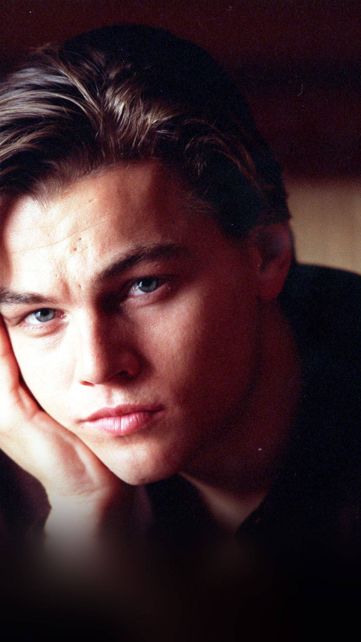 Leonardo DiCaprio, intense blue eyes, dimly lit portrait, Full HD Phone Wallpaper