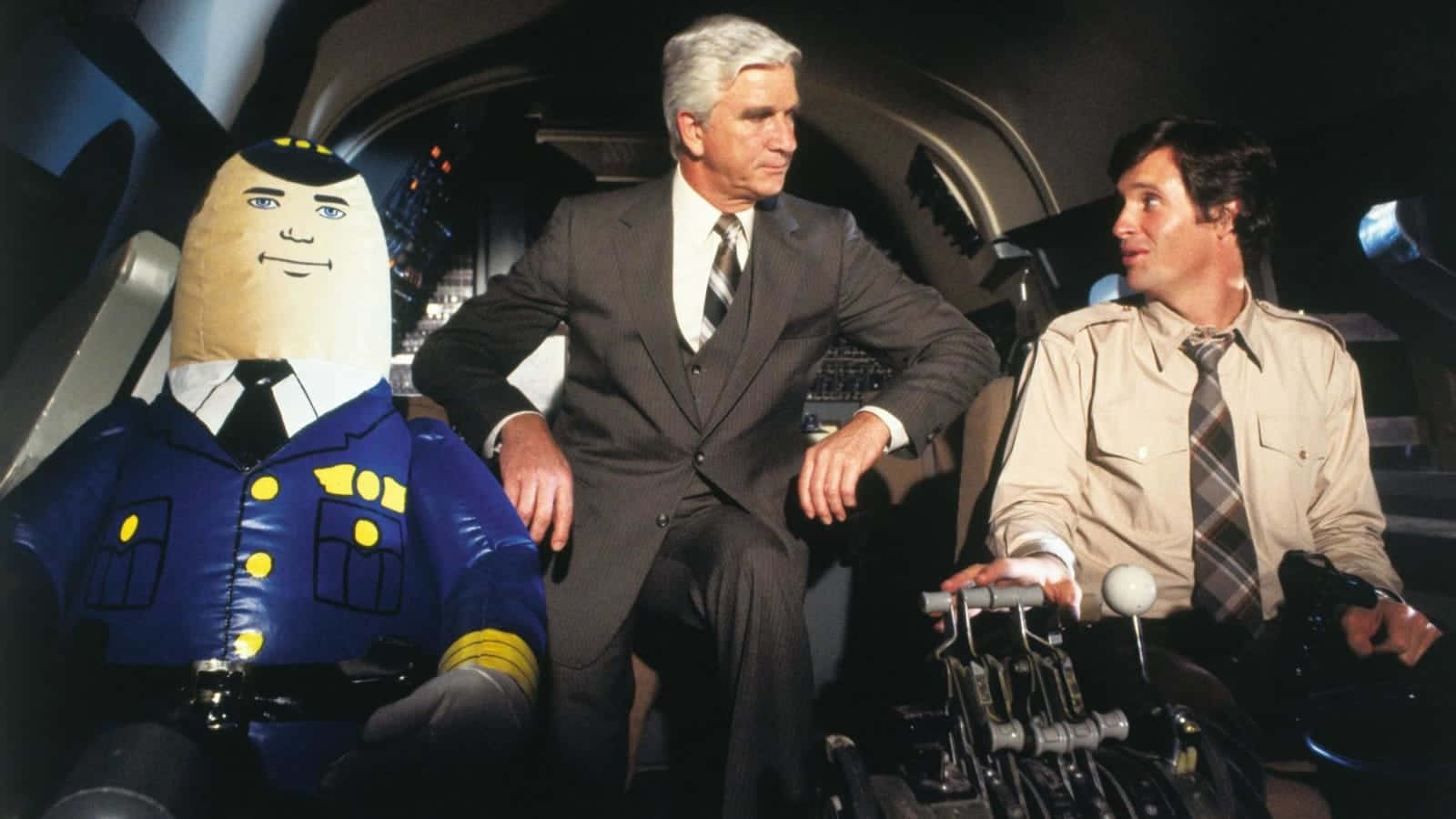 Leslie Nielsen, spaceship cockpit, giant inflatable pilot costume, HD Desktop Wallpaper