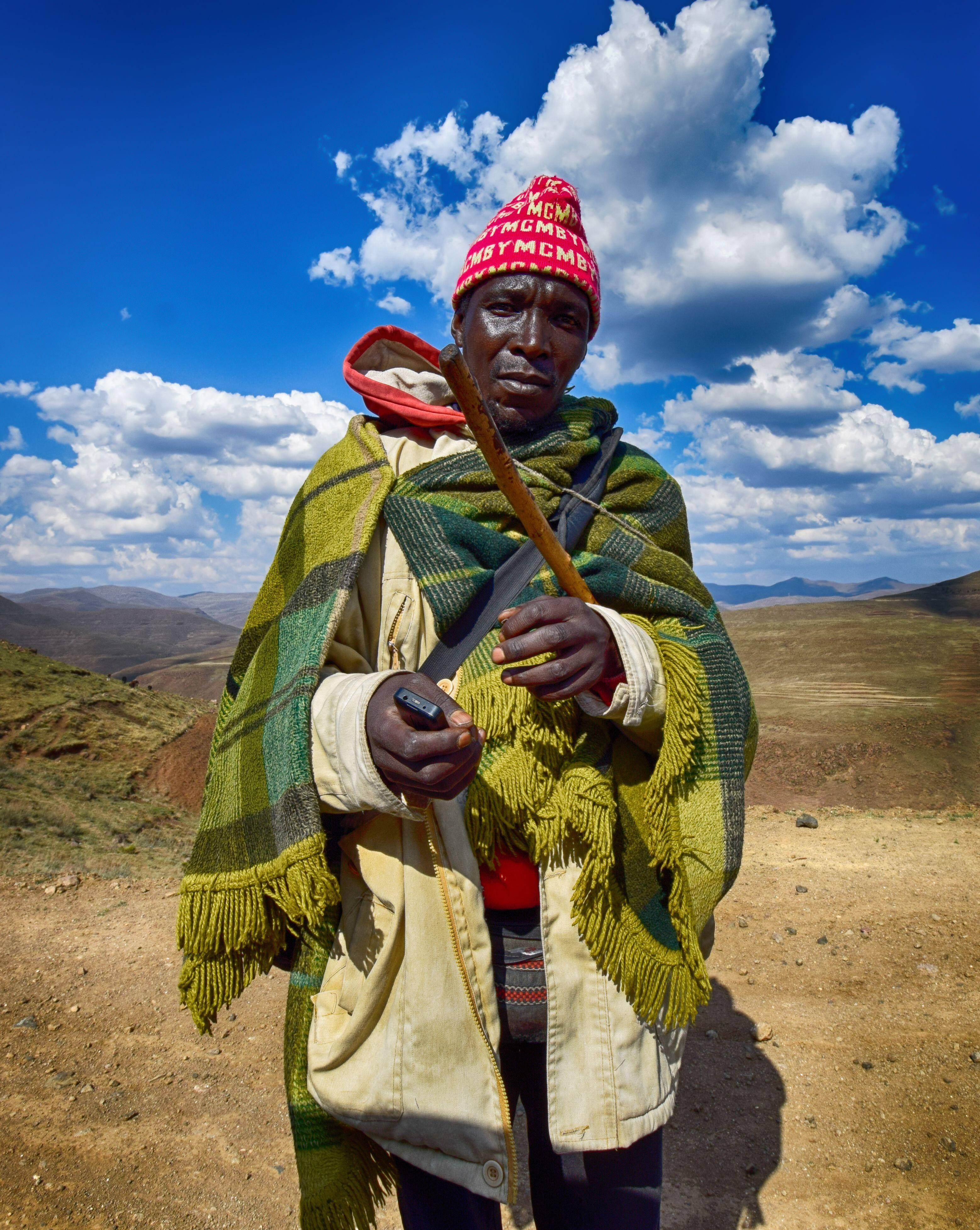 Lesotho Man, red knit cap, green plaid shawl, 4K Phone Wallpaper