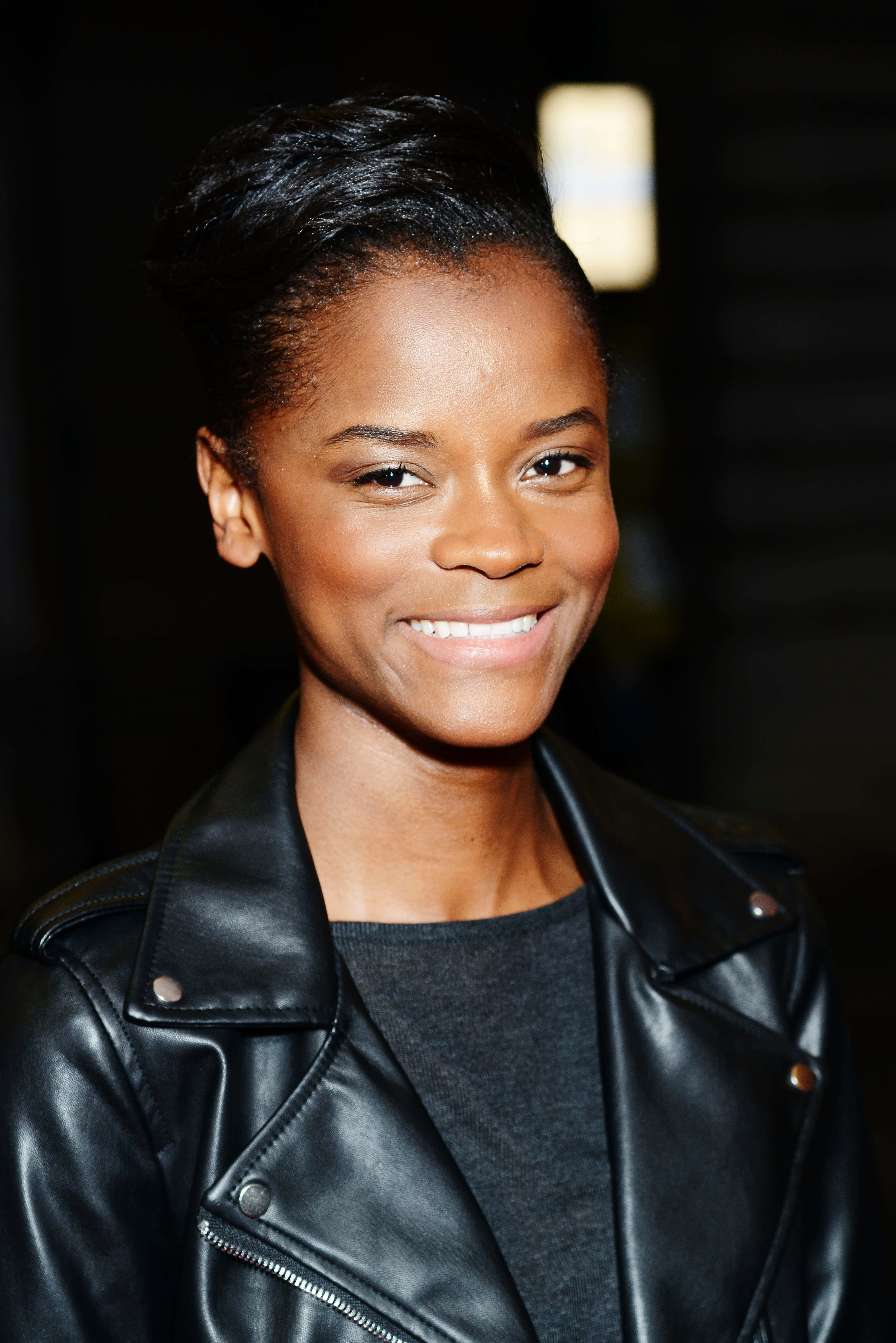 Letitia Wright, black leather jacket, dimly lit background, 5K Phone Wallpaper