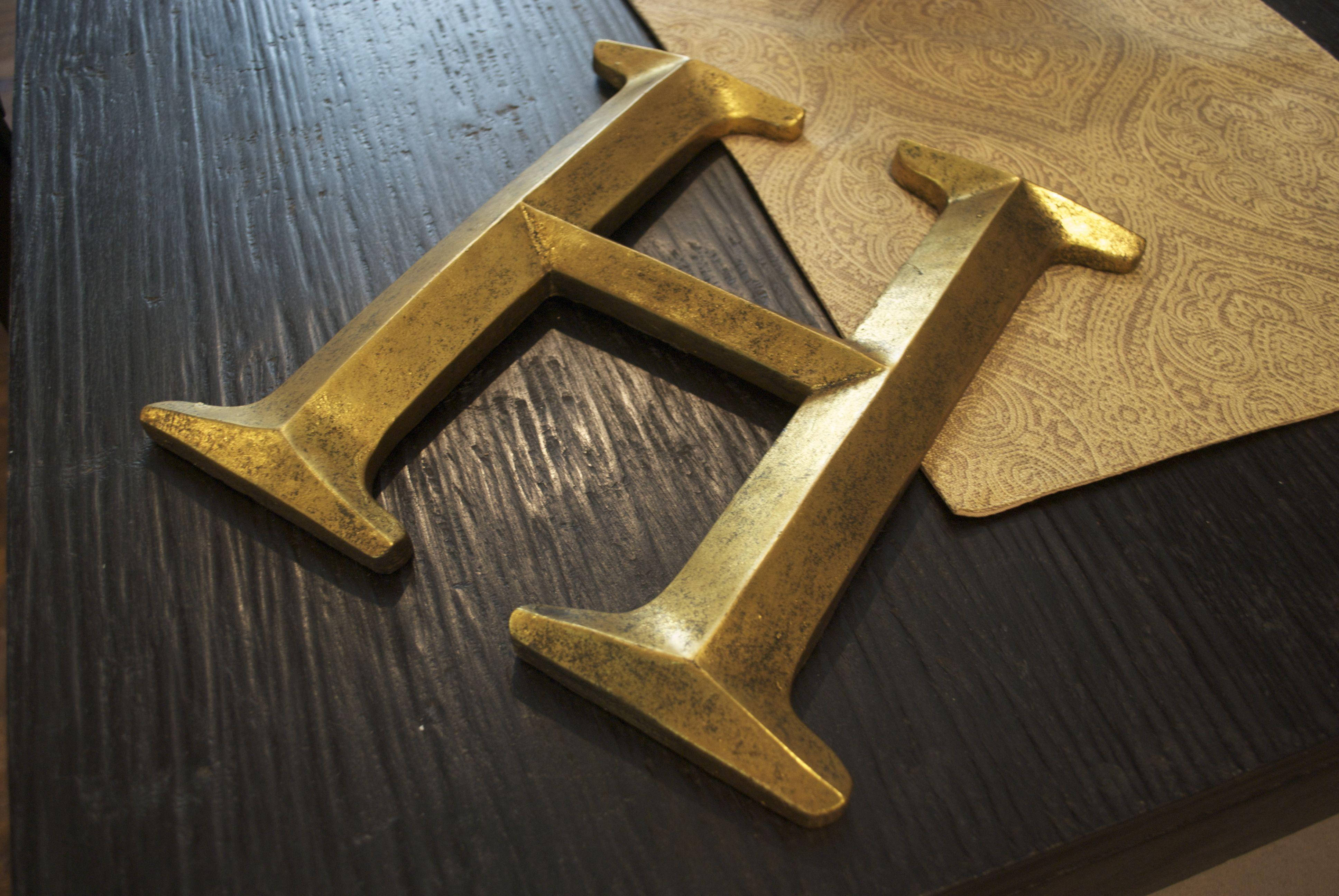 golden ornate letter H, dark wood surface, patterned gold paper, 4K Desktop Wallpaper