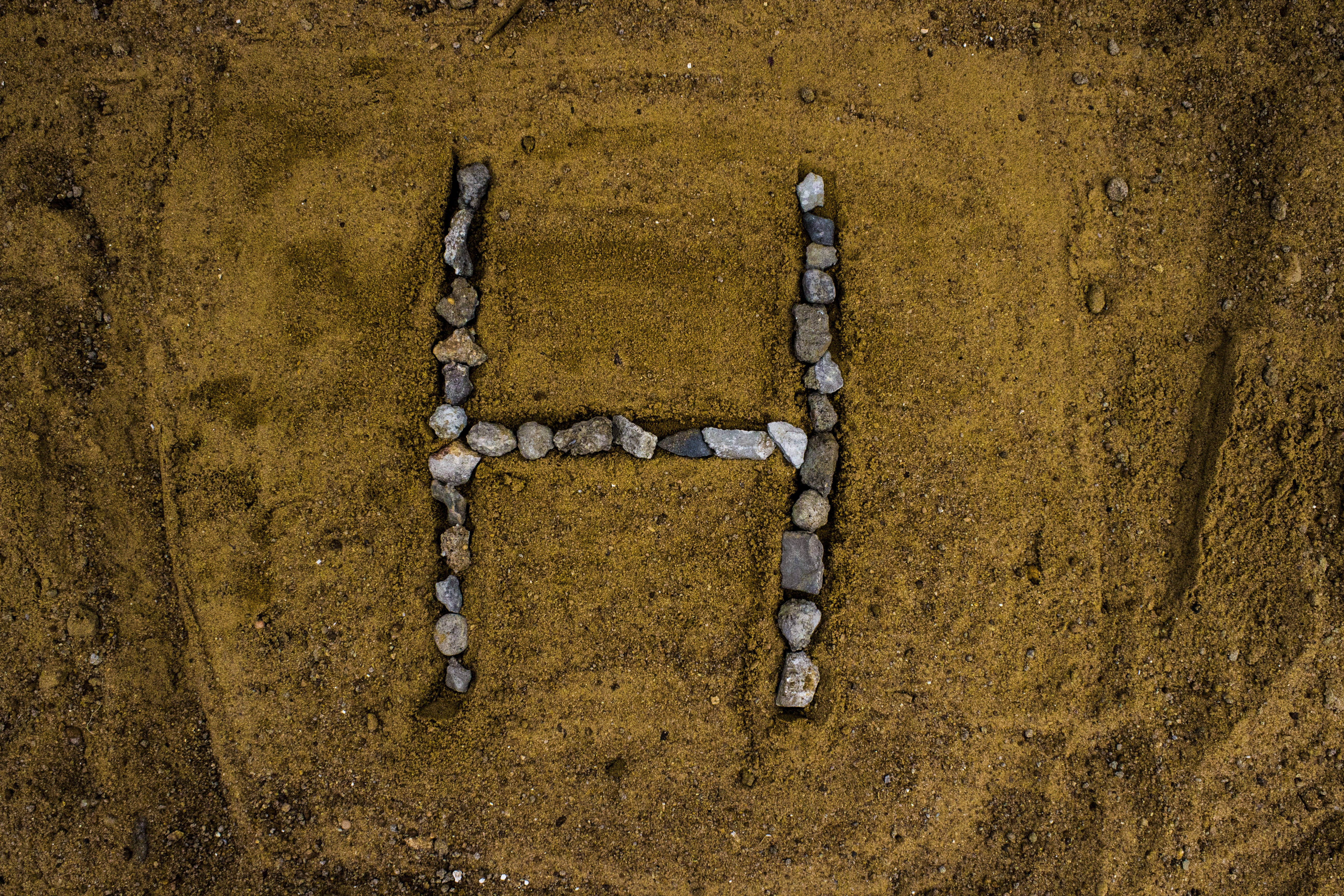 Letter H, small stones, textured brown earth, 5K Desktop Wallpaper