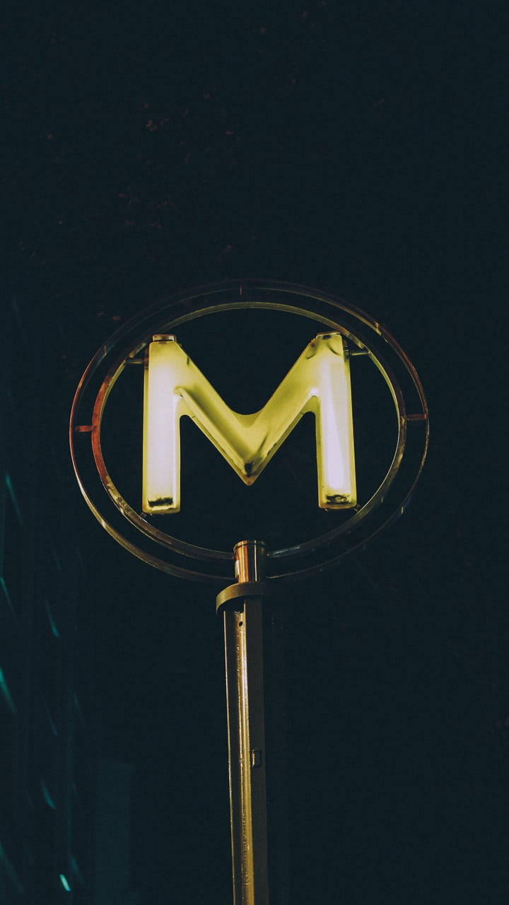 Metallic Letter M, glowing yellow neon, circular frame, HD Phone Wallpaper