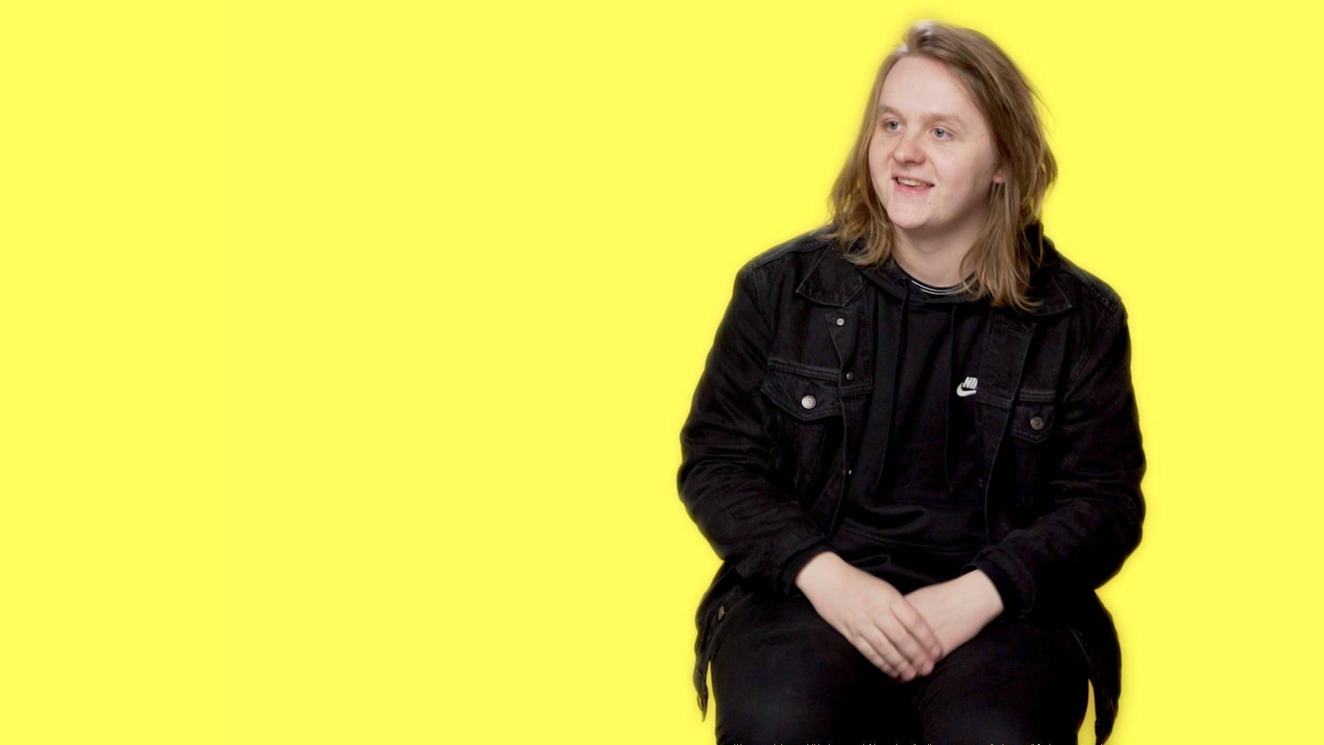 Lewis Capaldi, black jacket, bright yellow background, Full HD Desktop Wallpaper