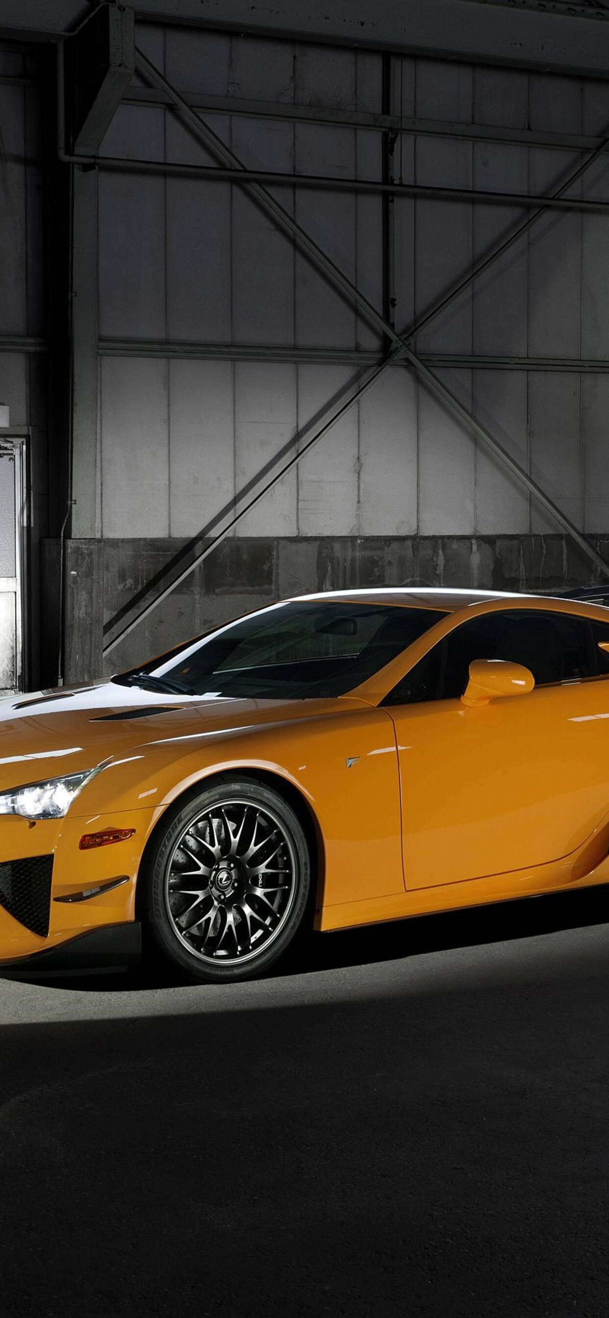 Yellow Lexus, vibrant orange sports car, dramatic lighting, 2K Phone Wallpaper