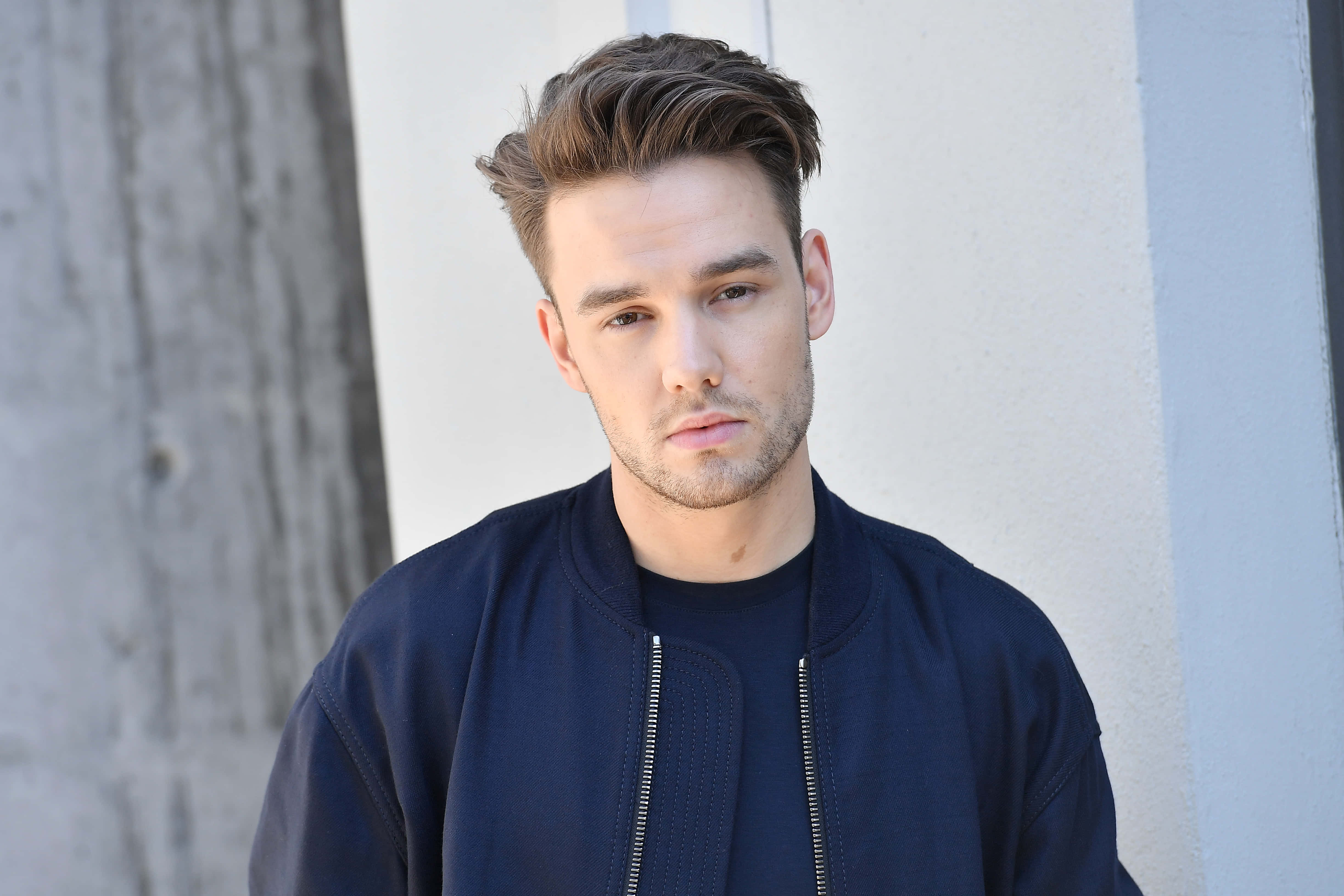 Liam Payne, navy bomber jacket, textured concrete wall, 4K Desktop Wallpaper