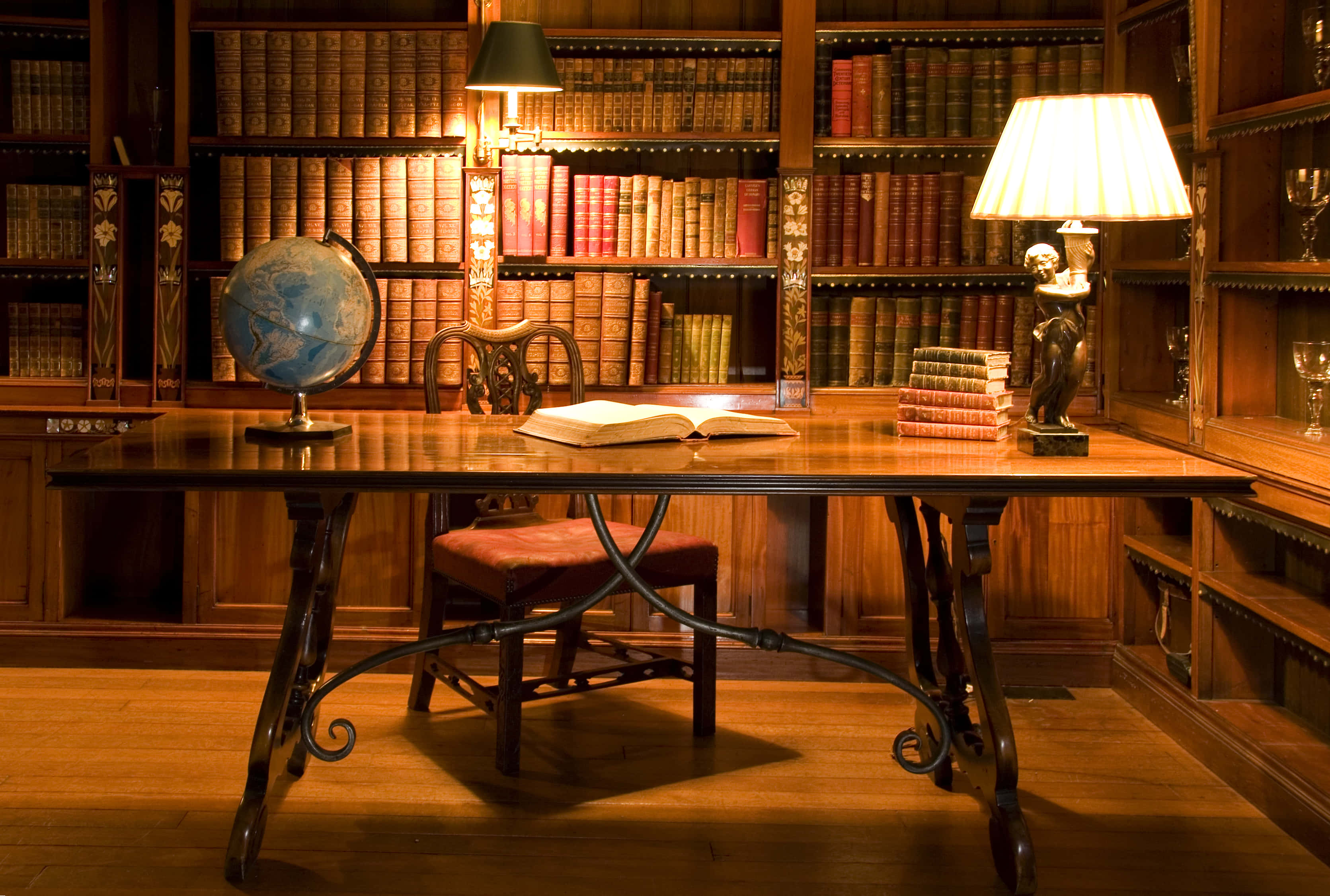 wooden study desk, open book globe, lamps, 2K Desktop Wallpaper