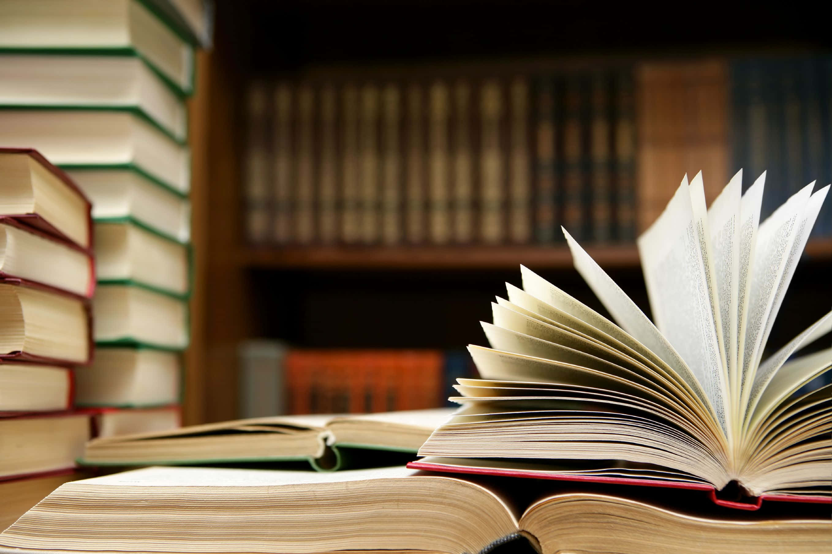 open book, fanned pages, wooden table, 2K Desktop Wallpaper