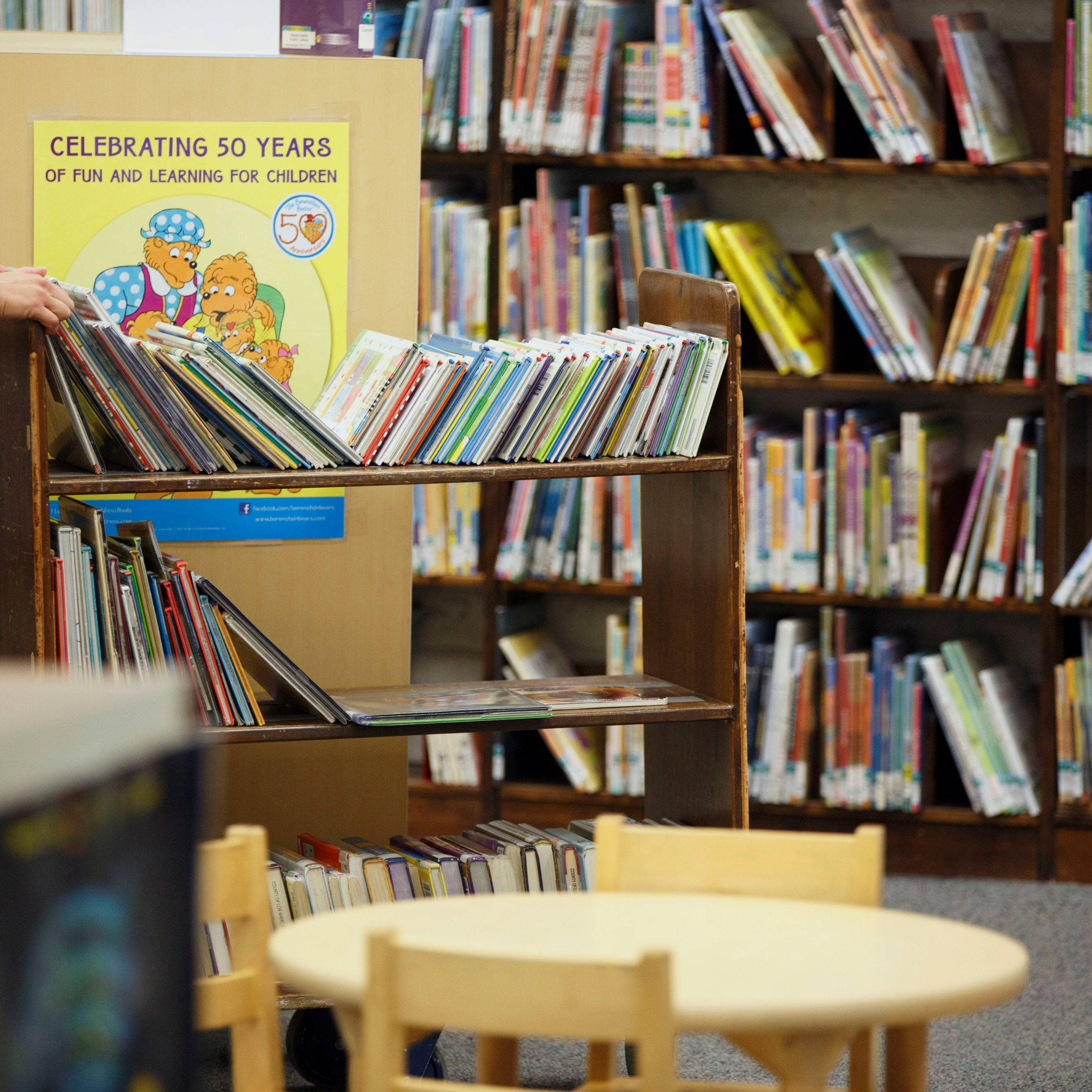 child's library corner, wooden shelves, colorful books, 2K Desktop Wallpaper