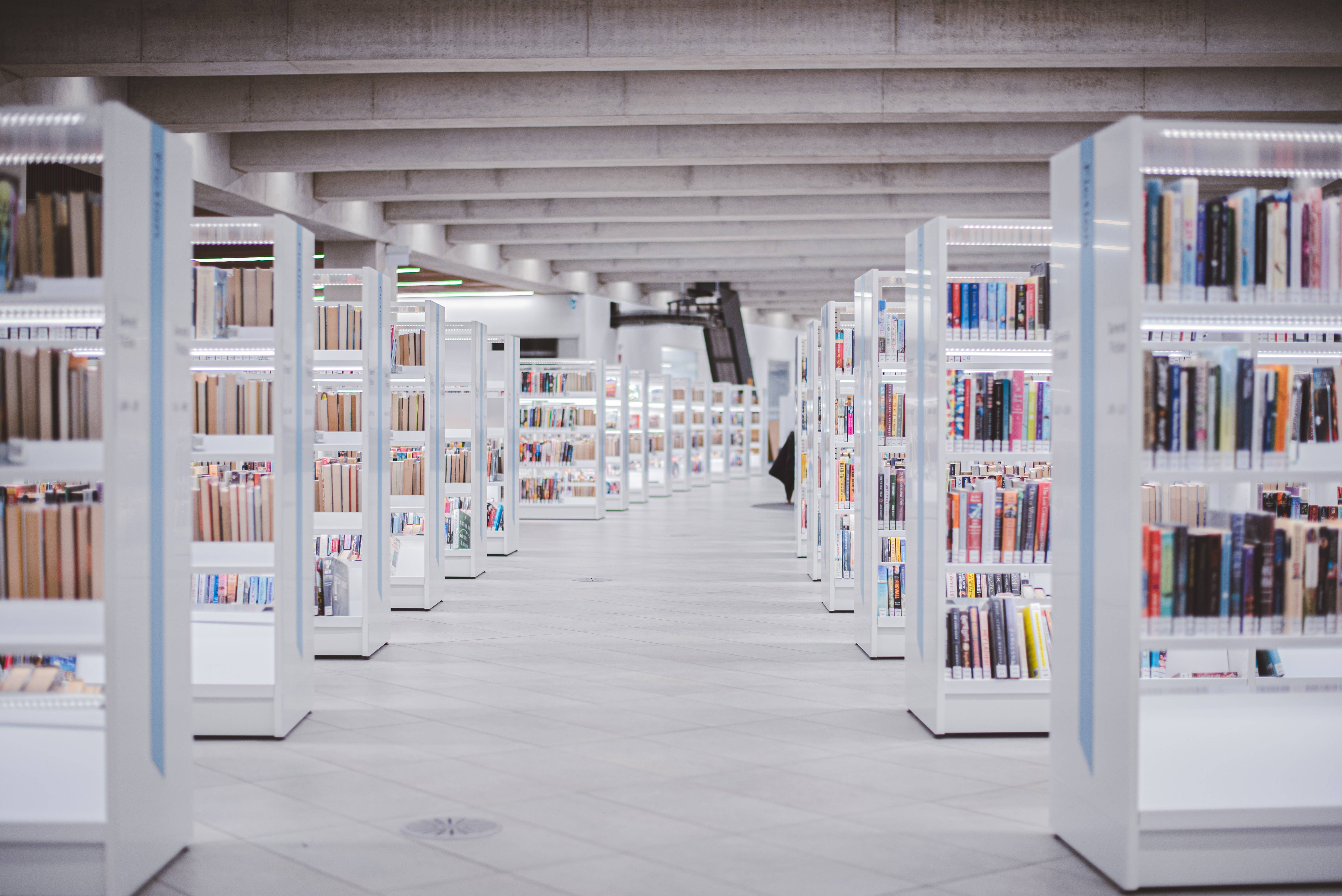 elegant minimalist library, white bookshelves, colorful books, 5K Desktop Wallpaper