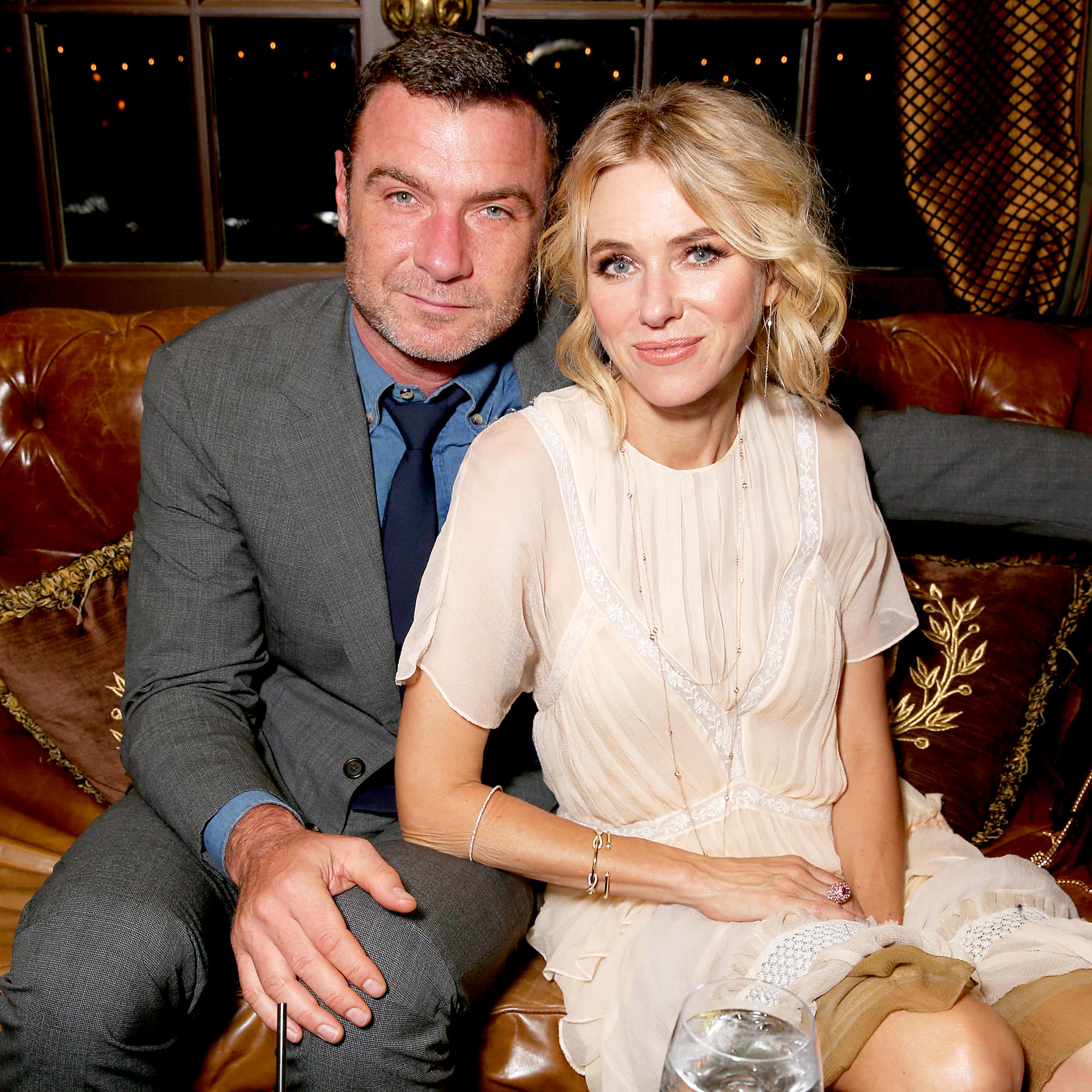 Liev Schreiber, rich brown leather couch, warmly lit indoor setting, Full HD Desktop Wallpaper