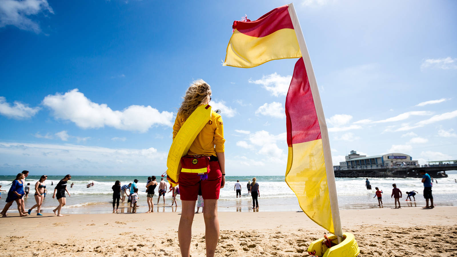 woman lifeguard, yellow and red uniform, bright blue sky, HD Desktop Wallpaper