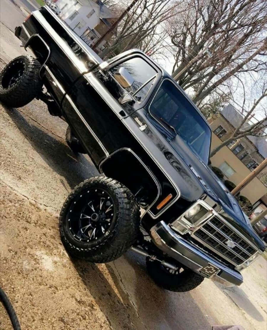 black lifted classic truck, oversized tires, residential street, SD Phone Wallpaper