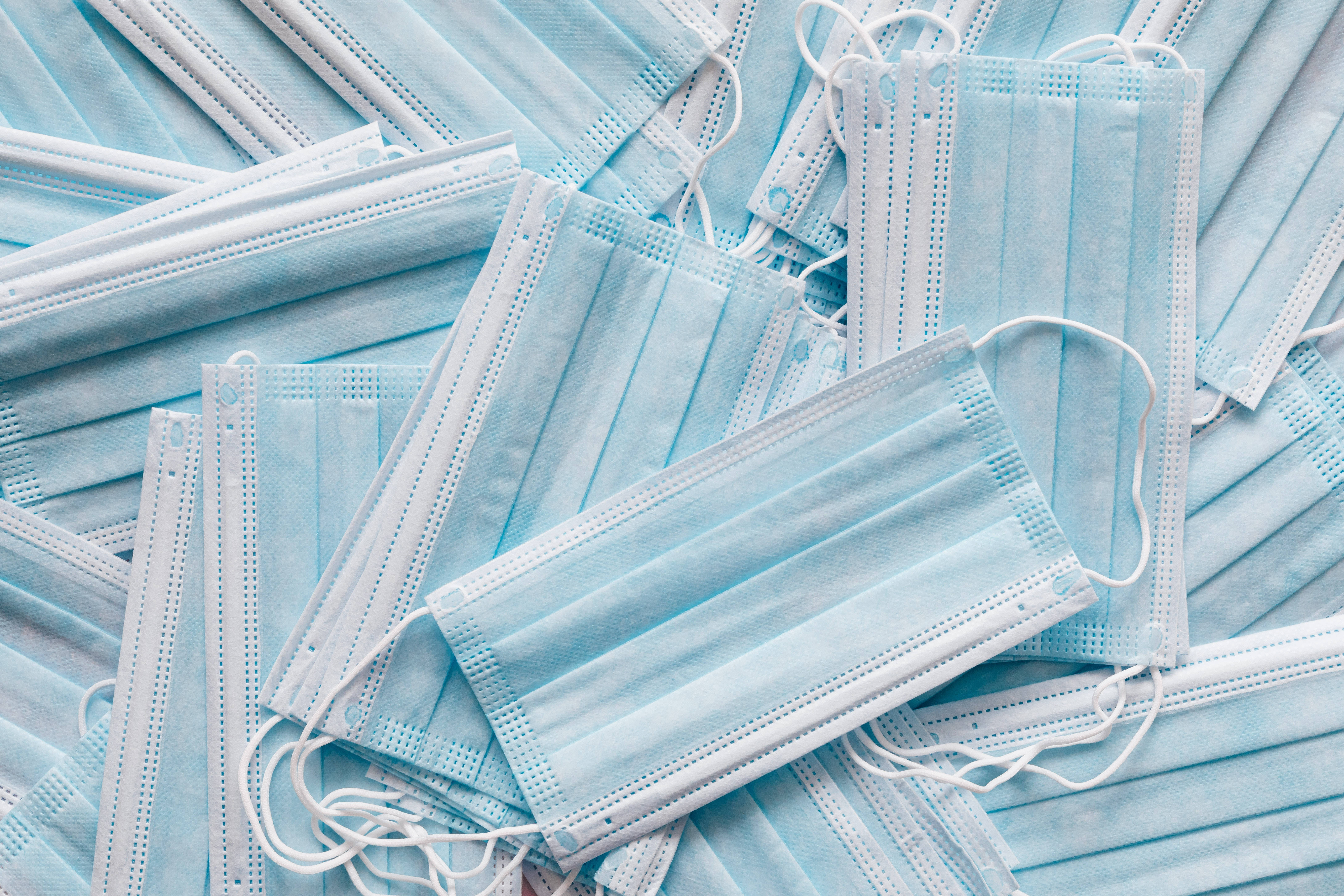 light blue surgical masks, white ear loops, top-down view, 5K Desktop Wallpaper