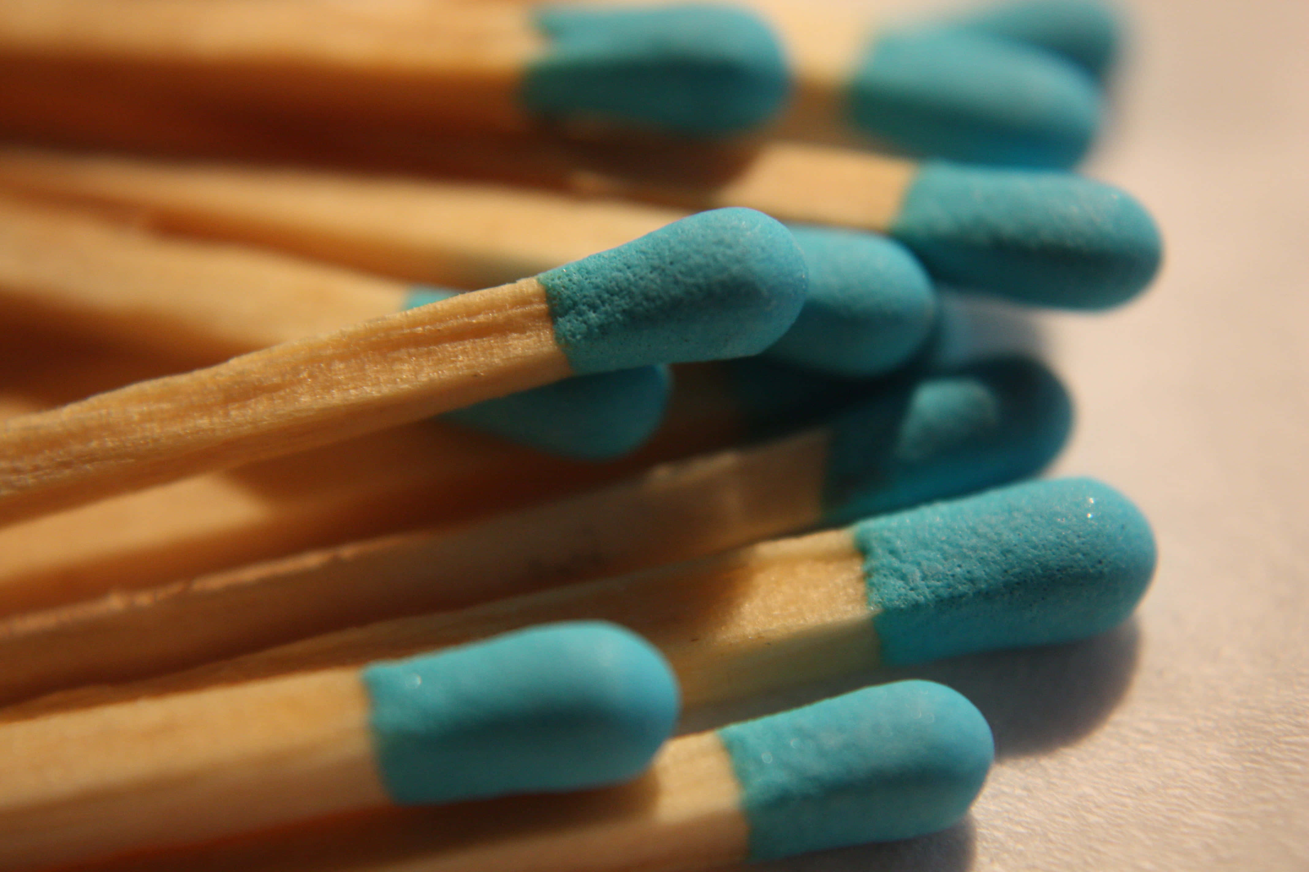 light brown wooden matches, vibrant blue tips, shallow pile, 4K Desktop Wallpaper