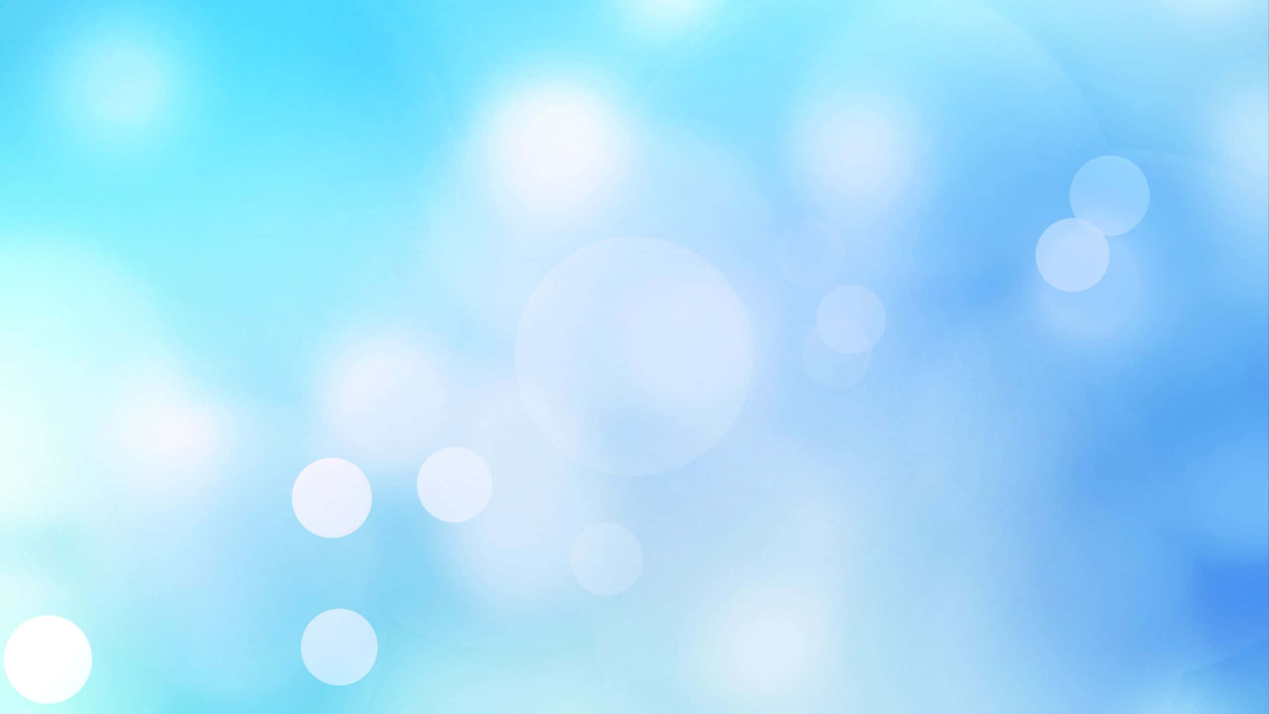 light blue laptop, soft blue gradient, glowing white bokeh circles, 2K Desktop Wallpaper