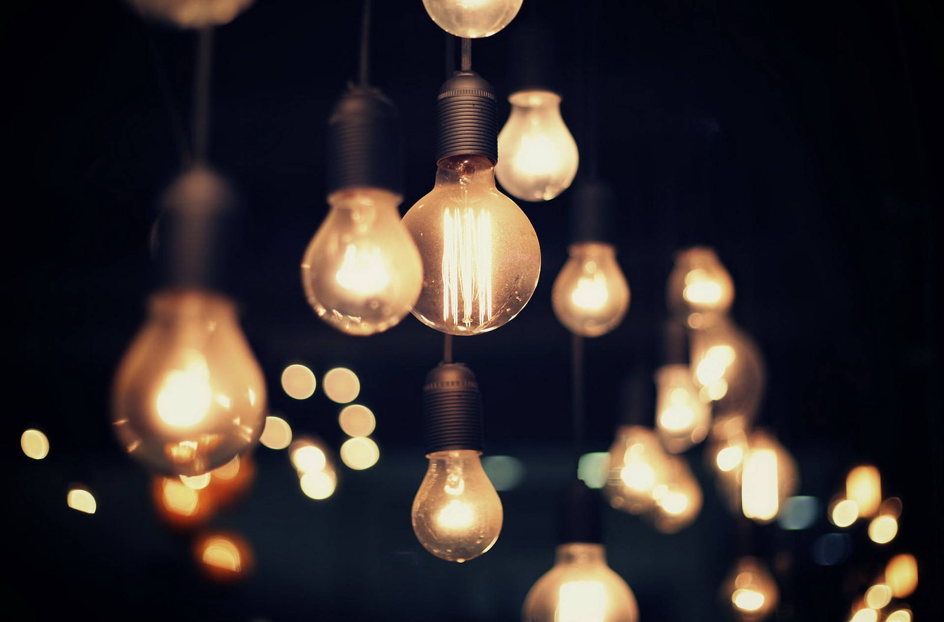 hazy yellow light bulbs, warm glowing filament, dark backdrop, Full HD Desktop Wallpaper