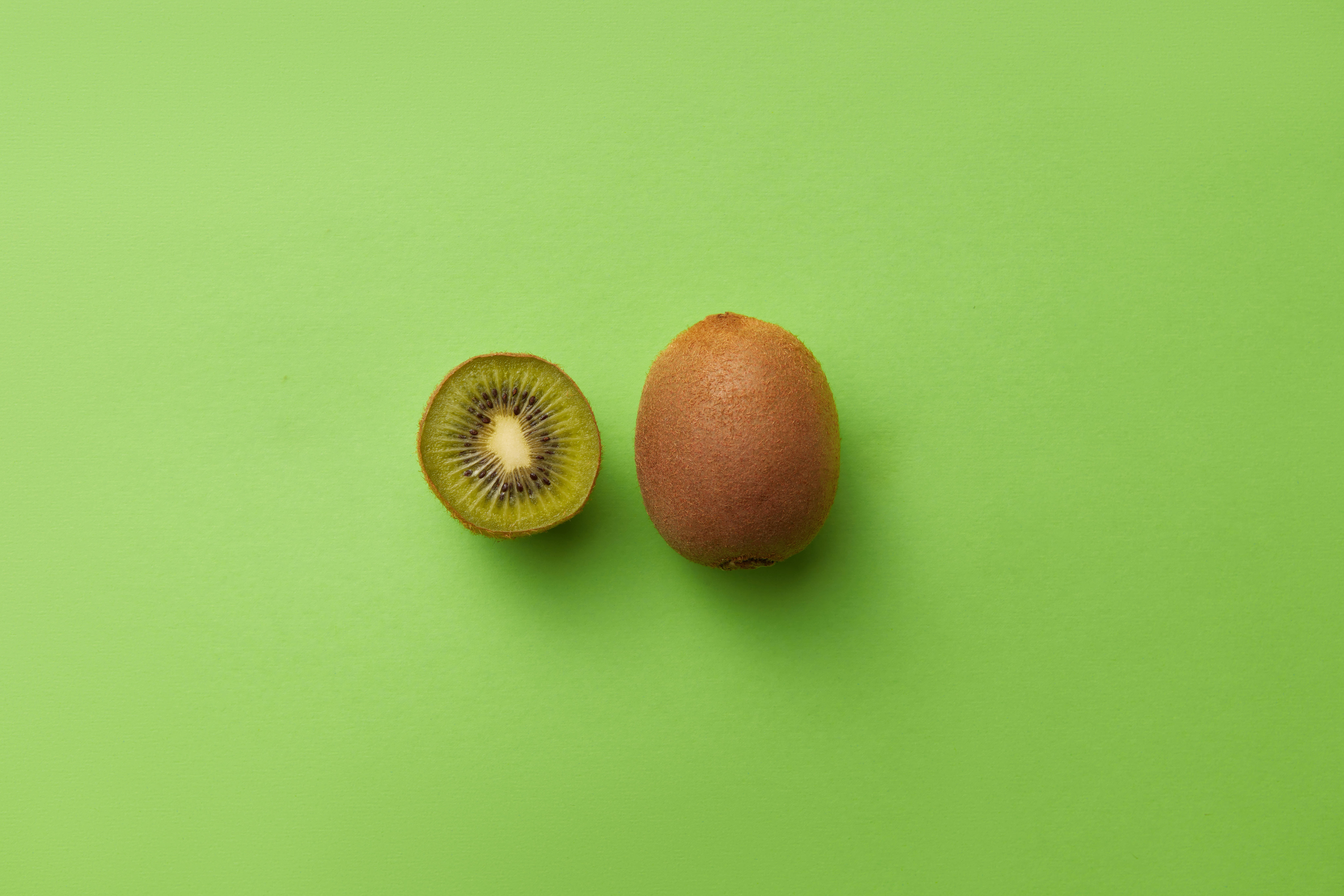 kiwi fruit, vibrant lime green background, whole kiwi fruit, 8K Desktop Wallpaper