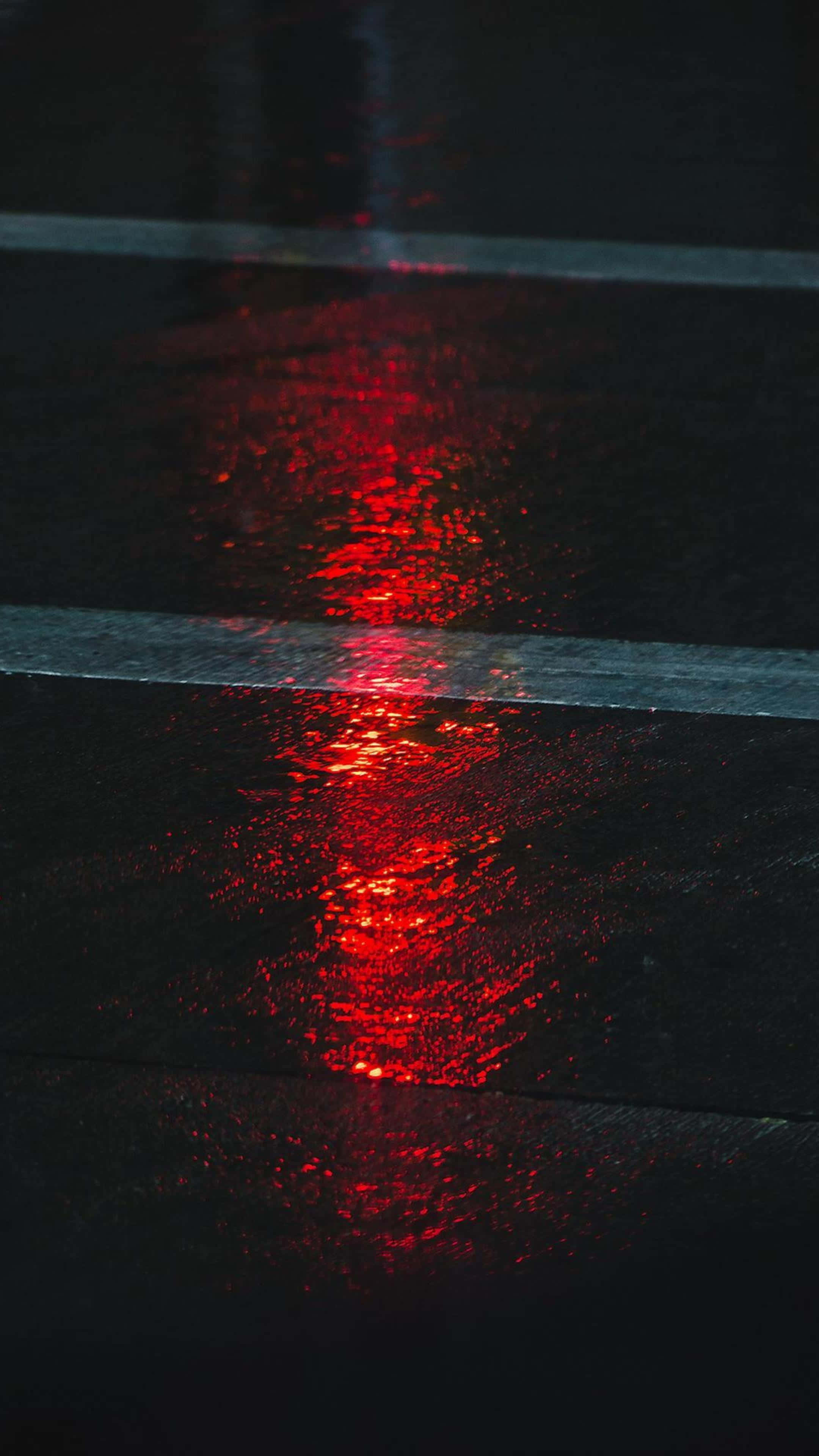 red glow, rain-slicked asphalt, distant taillight, 2K Phone Wallpaper