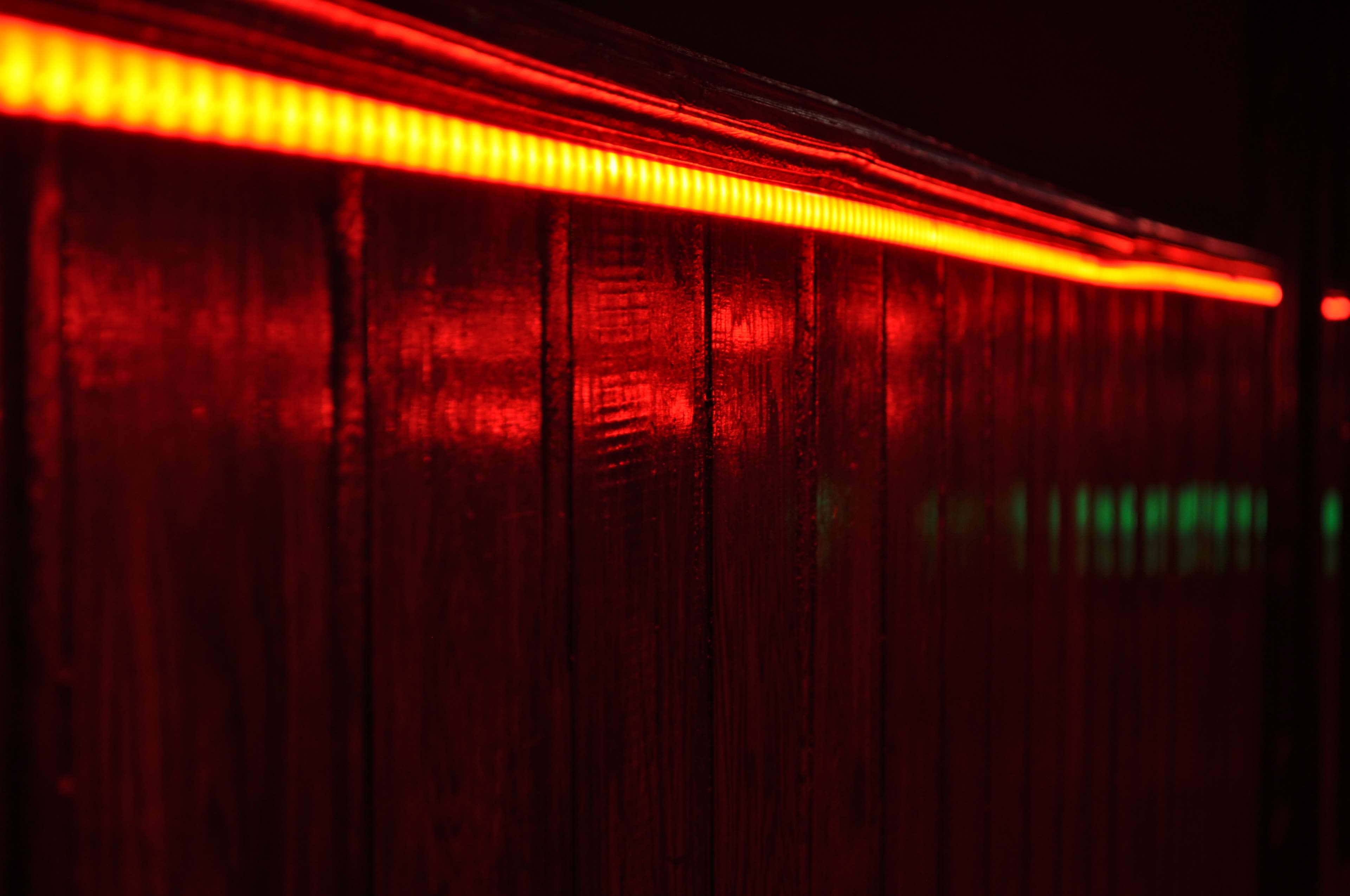 Light Red, red LED strip, dark wooden surface, 4K Desktop Wallpaper