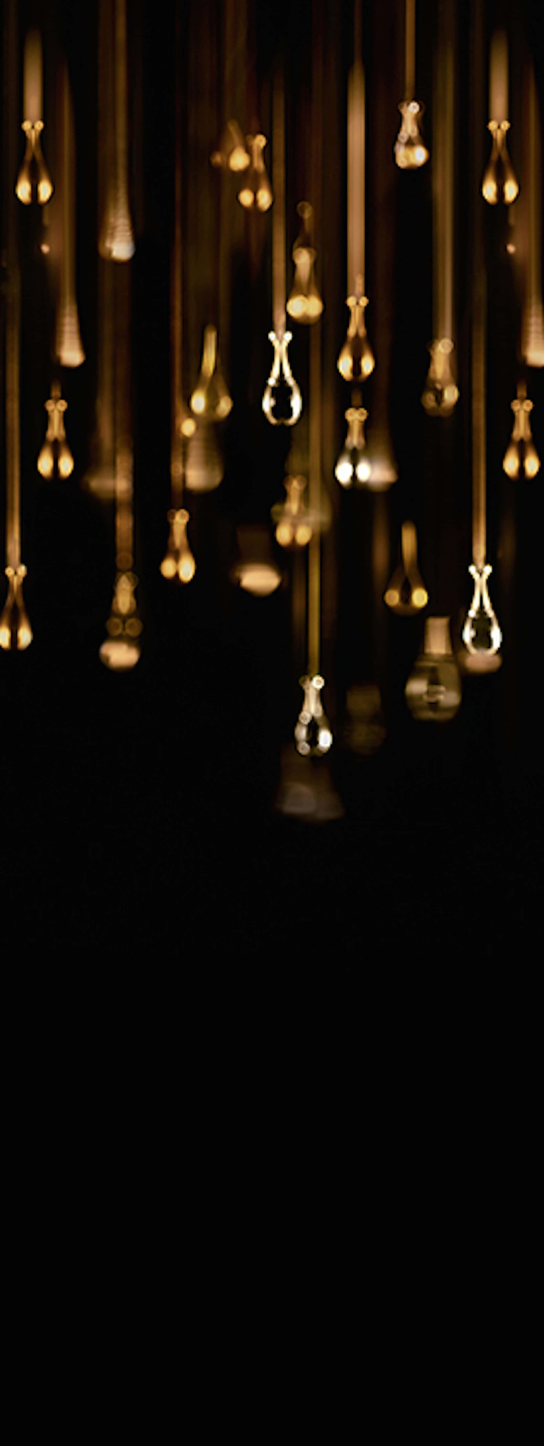 golden teardrop-shaped lights, deep black background, warm glowing ambiance, 5K Phone Wallpaper