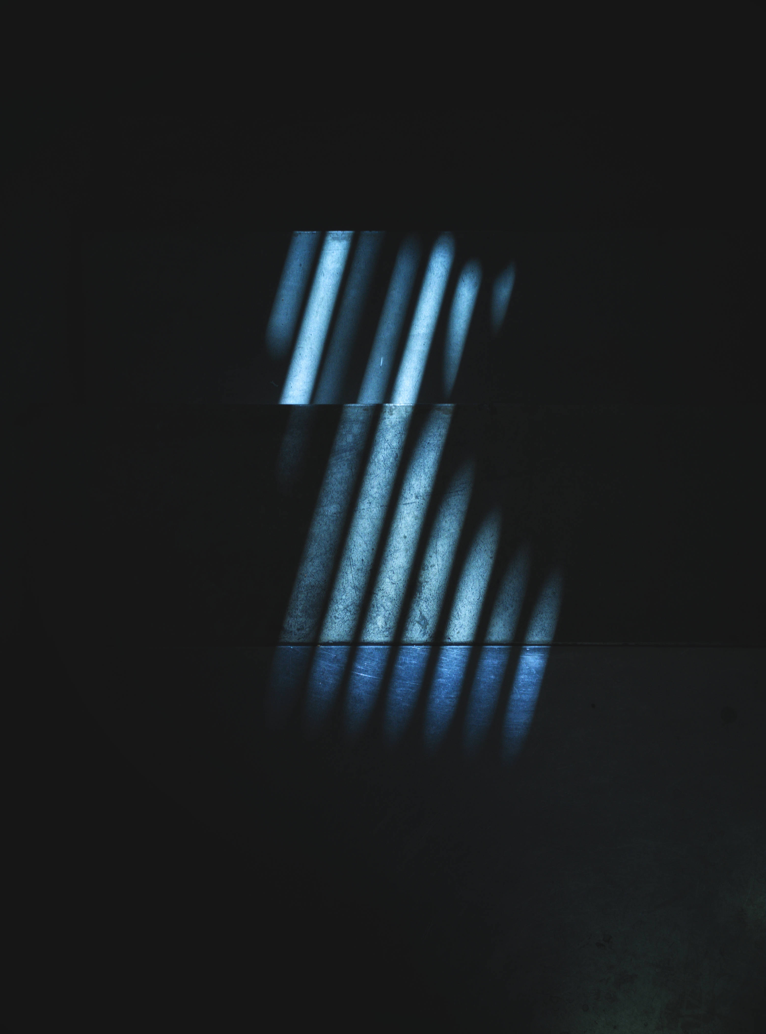 cool blue light beams, darkness, sharp geometric shadows, 4K Phone Wallpaper