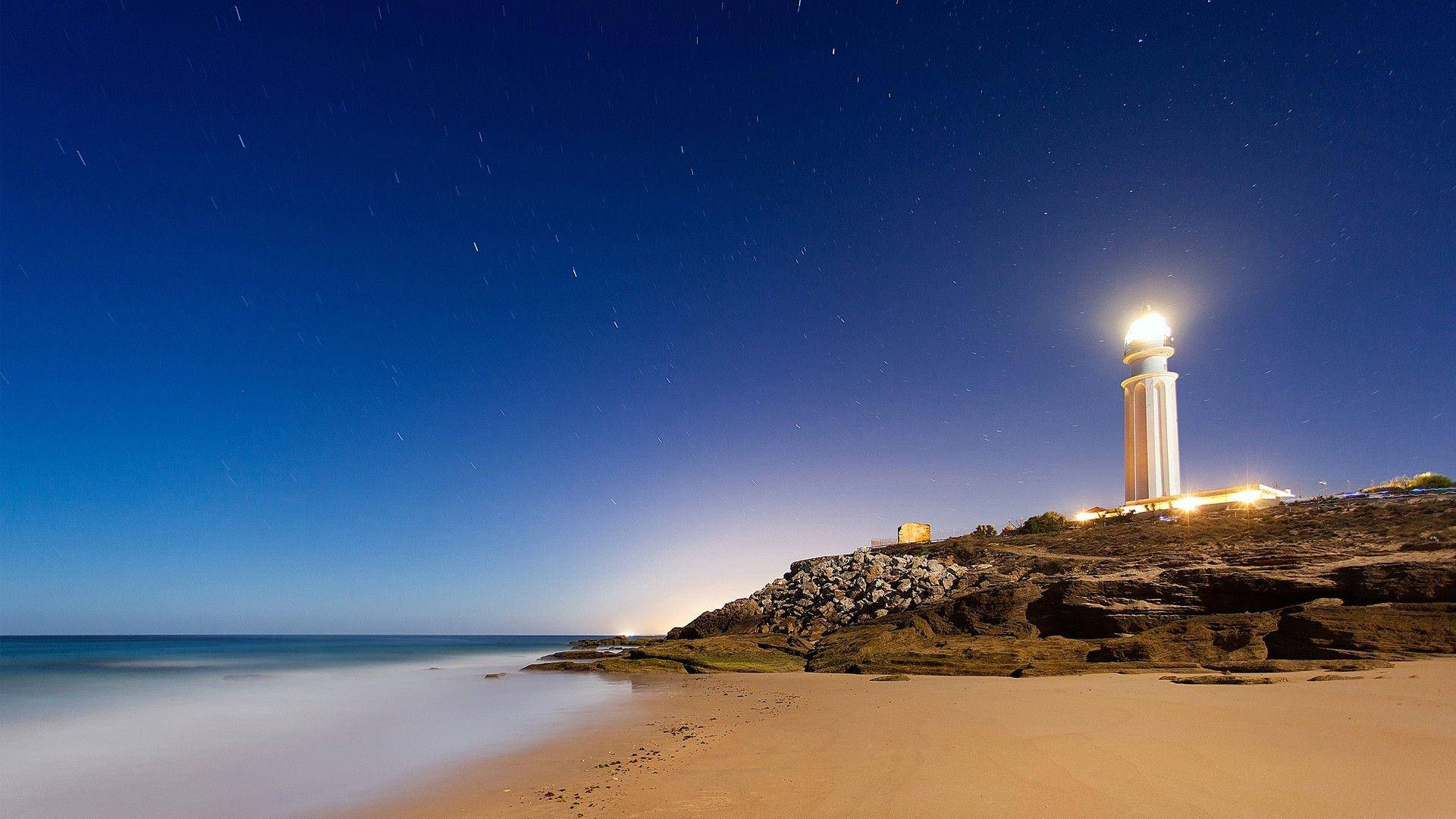 futuristic lighthouse, rocky cliff, starry night sky, Full HD Desktop Wallpaper